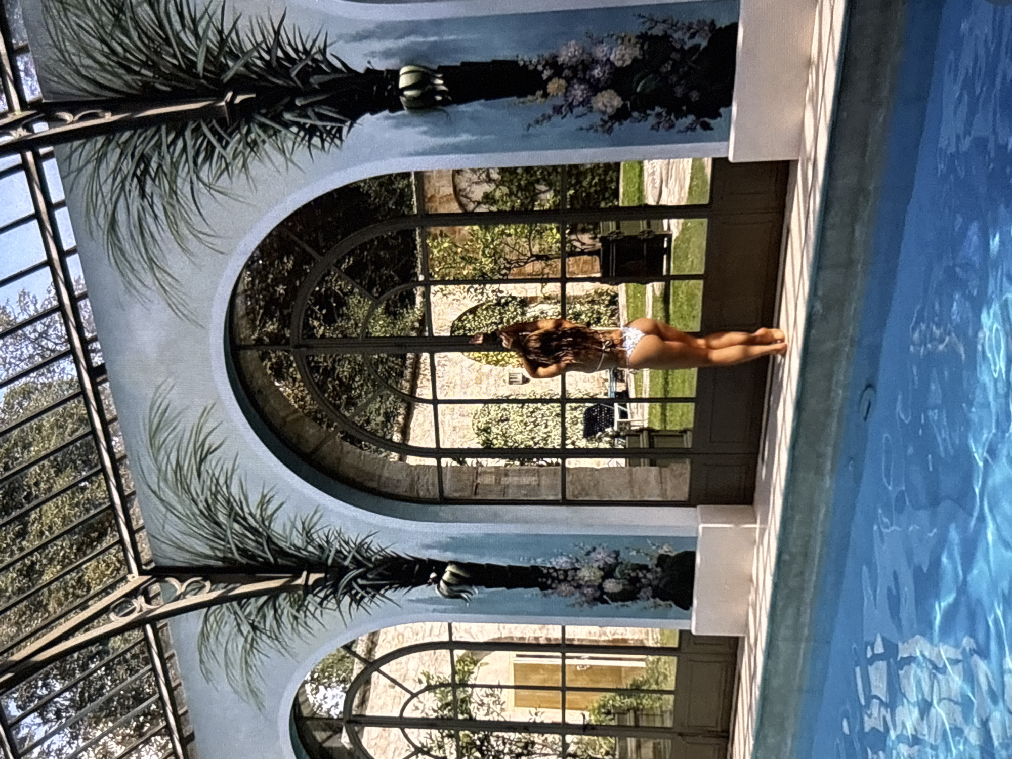 Woman poses by indoor pool in Yerevan