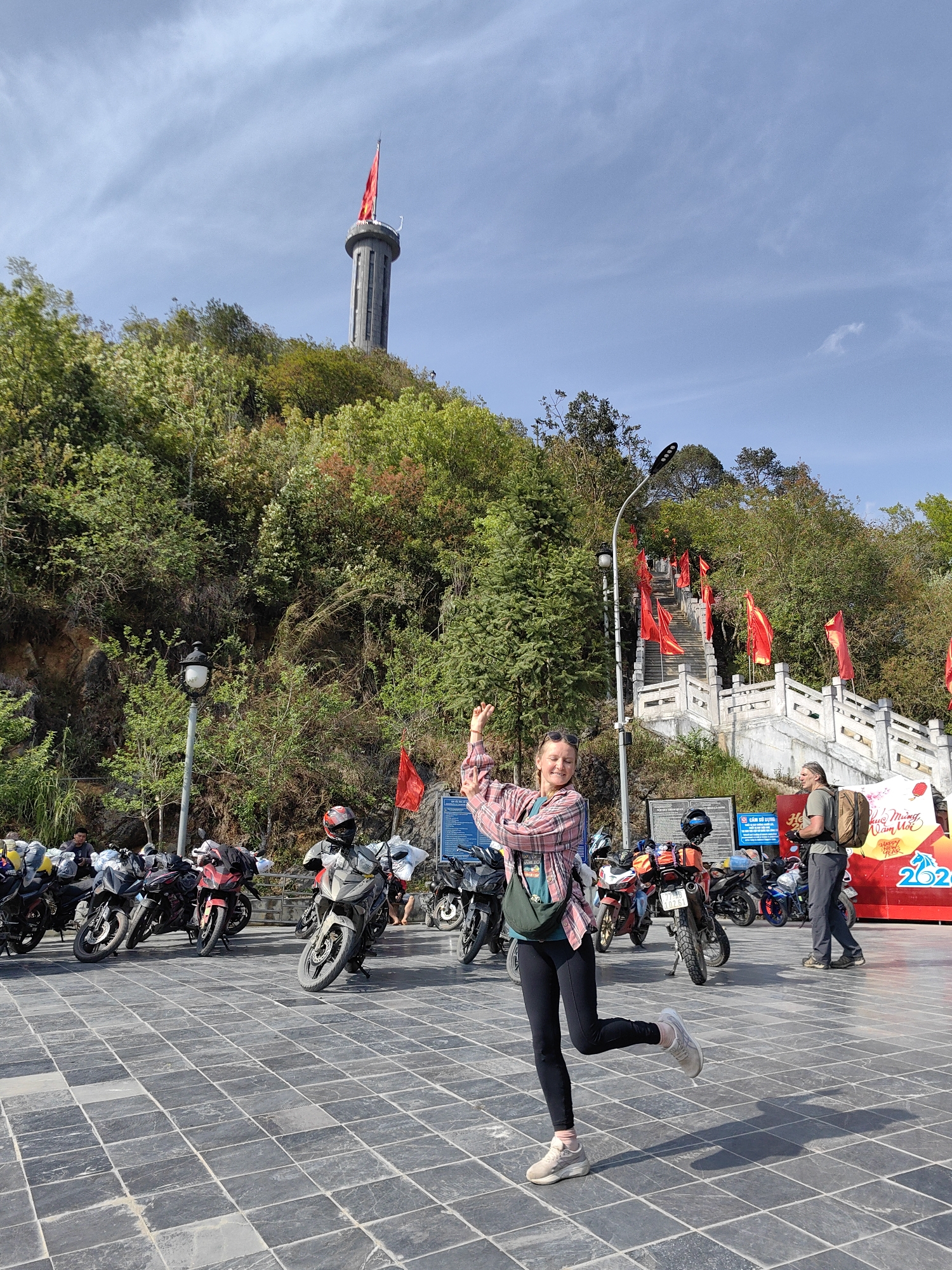 Woman poses for photo in Vietnamese commune square