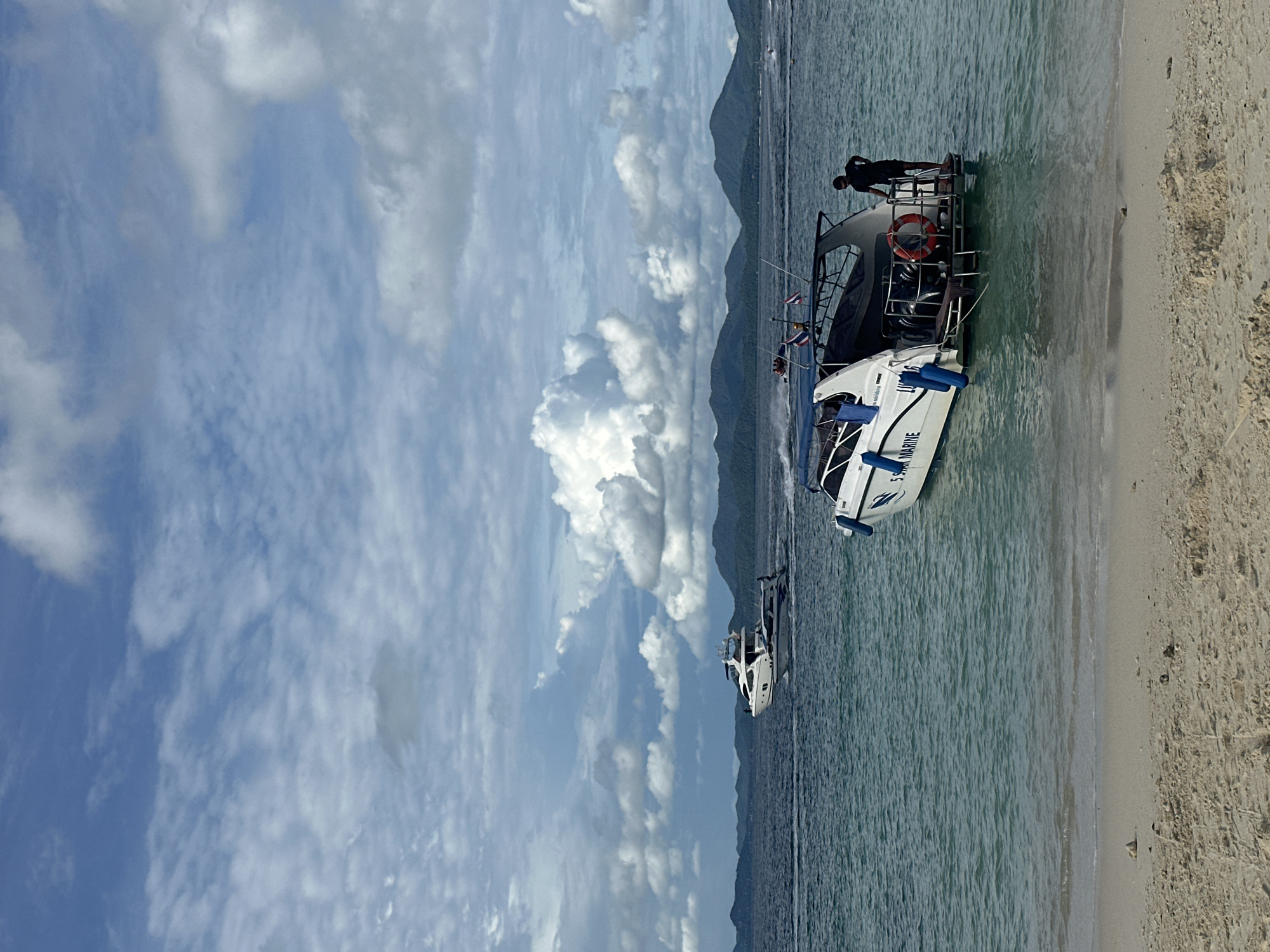Busy morning at a Phru Nai beach, boats and Jetski Club umbrellas