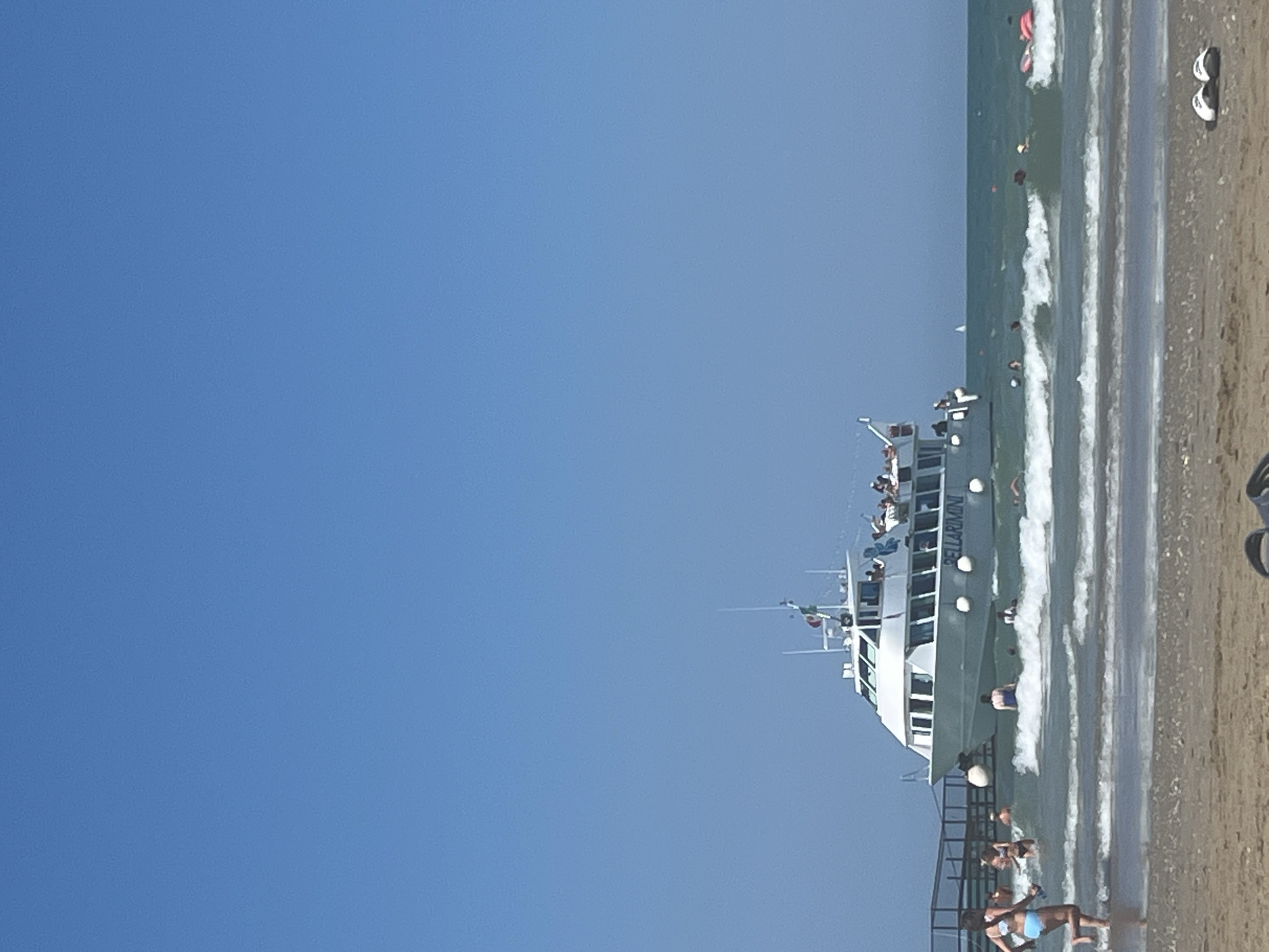 Kites, boats, and swimmers on a Rimini summer afternoon