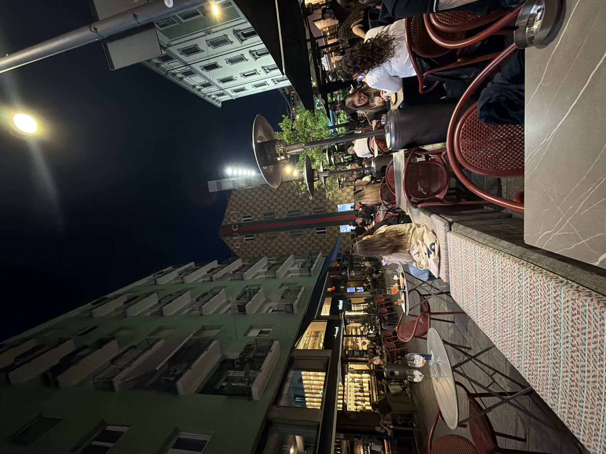 Evening outdoor dining scene captured in Milan