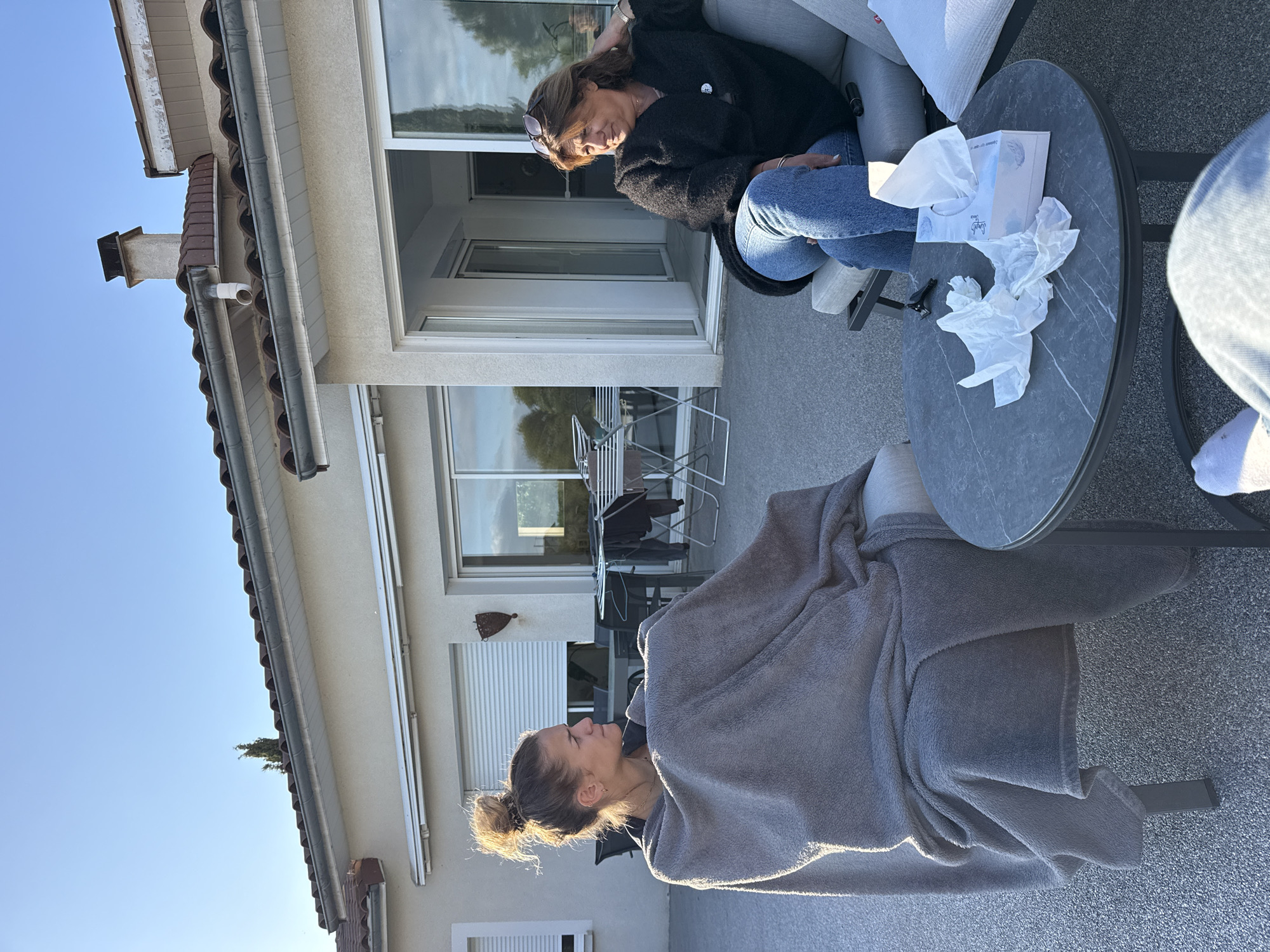 Quiet Sunday afternoon gathering on residential patio in Veauchette
