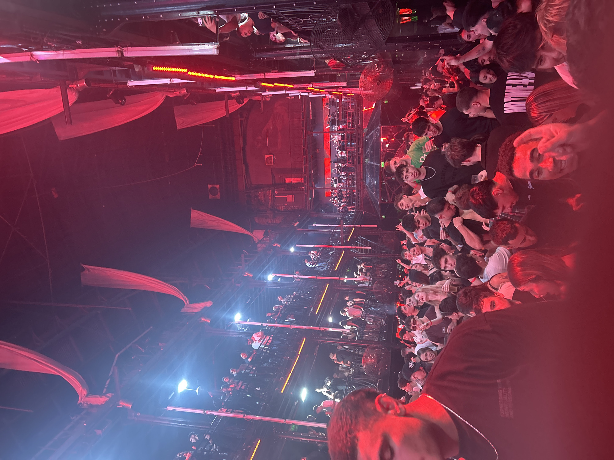 Indoor crowd gathers at red-lit event in Buenos Aires