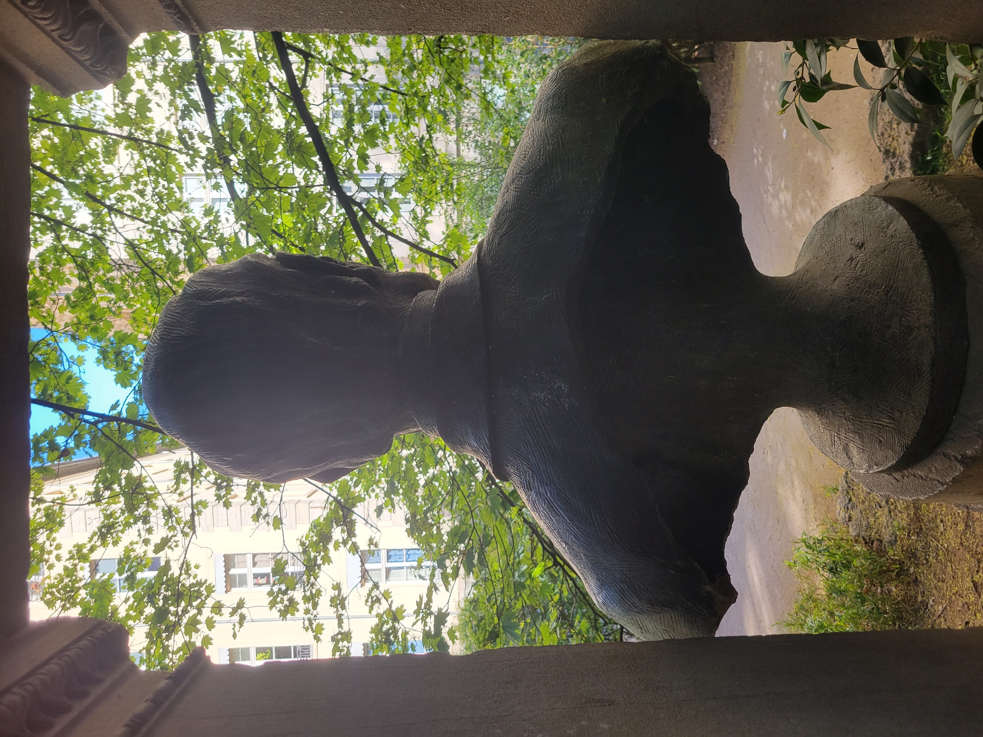Woman visits Lyon playground near historic stone bust