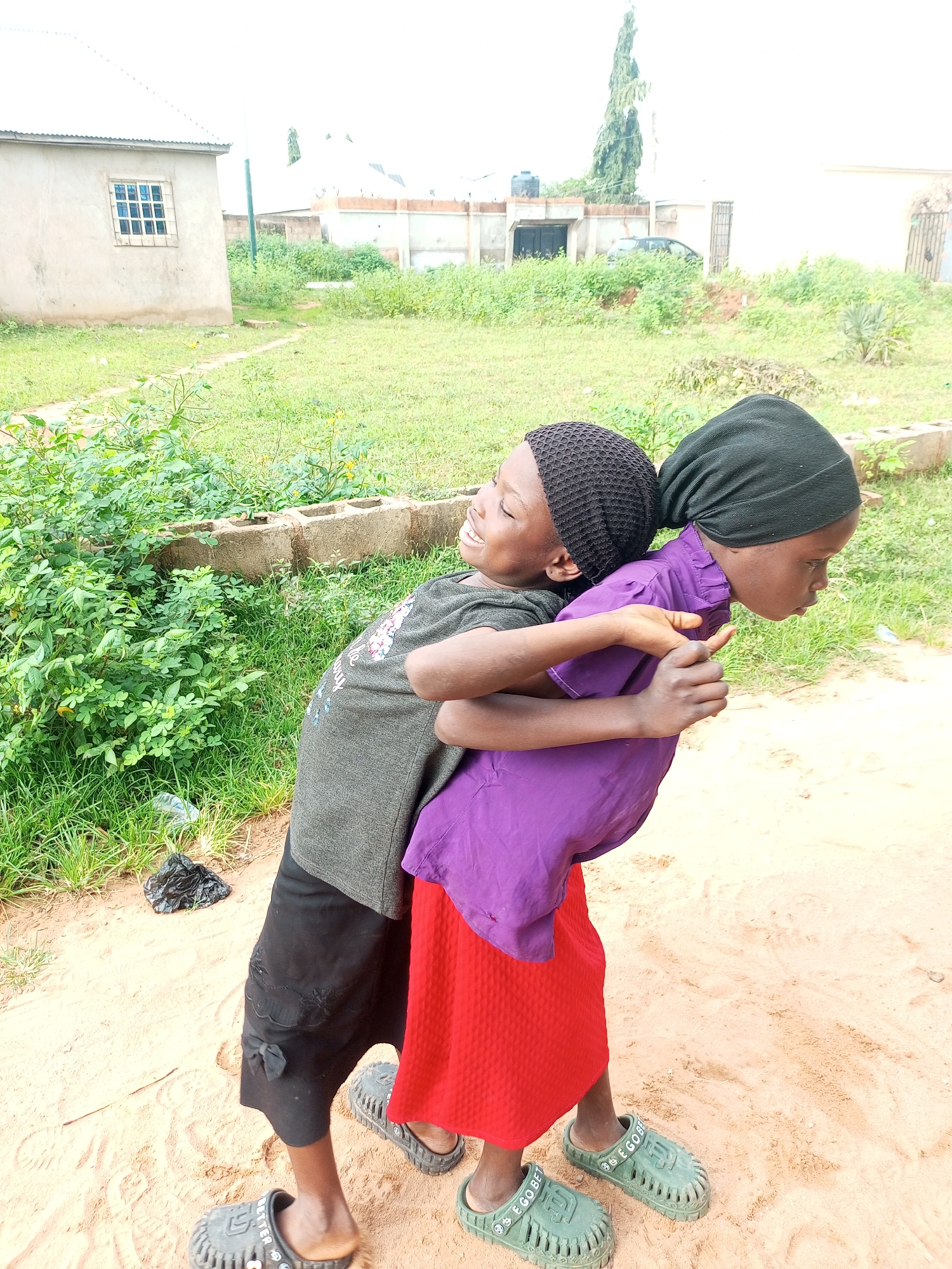 Kids playing and bonding on dusty streets in Tempure, Nigeria