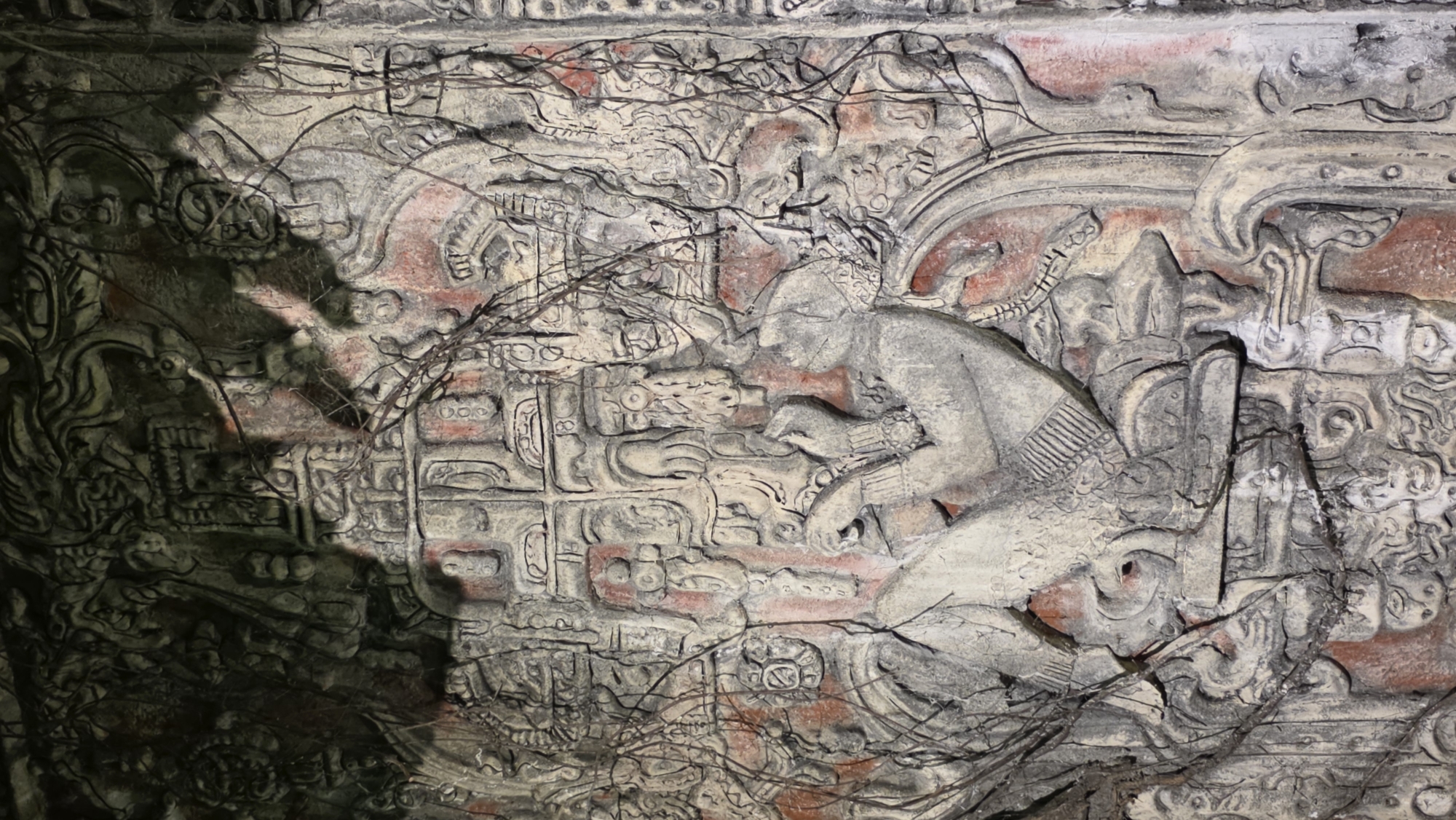Ancient Mayan-style stone carvings observed showing weathered figures and glyphs