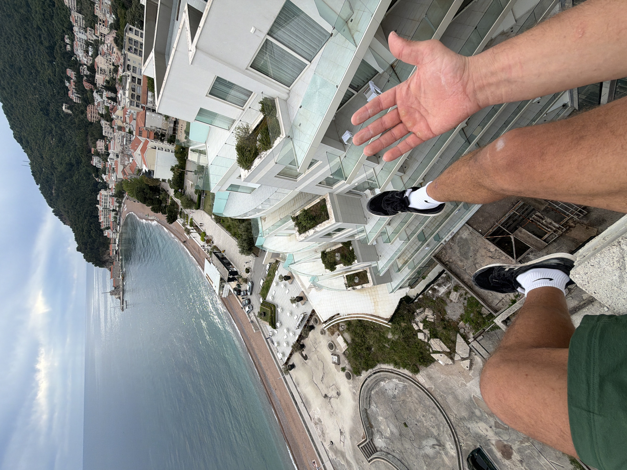 Person observed on rooftop overlooking Montenegro coastal town