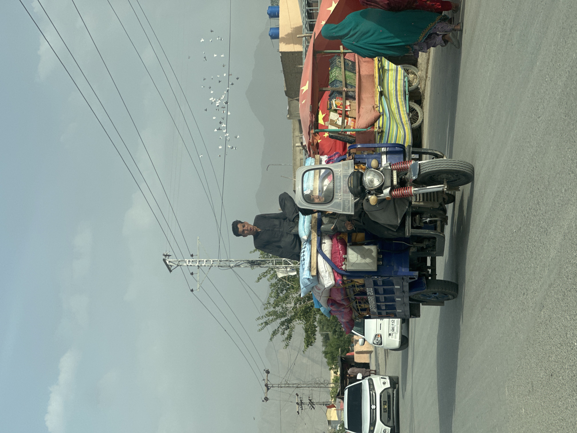 Commercial three-wheeler transports goods through Quetta streets