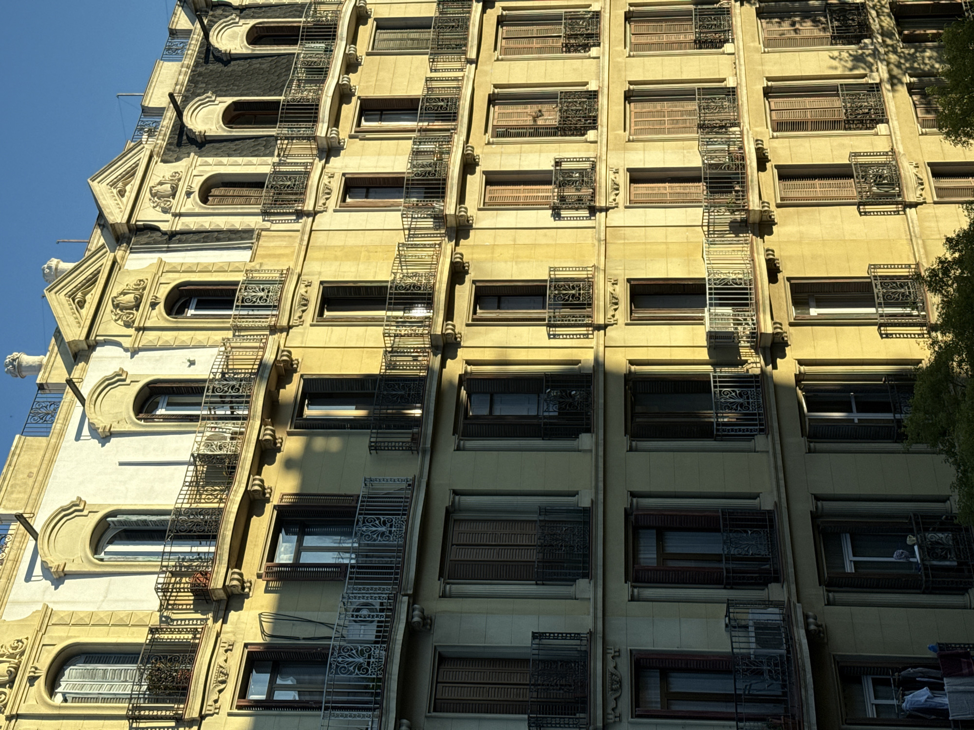 Barcelona building facade with decorative ironwork documented by witness