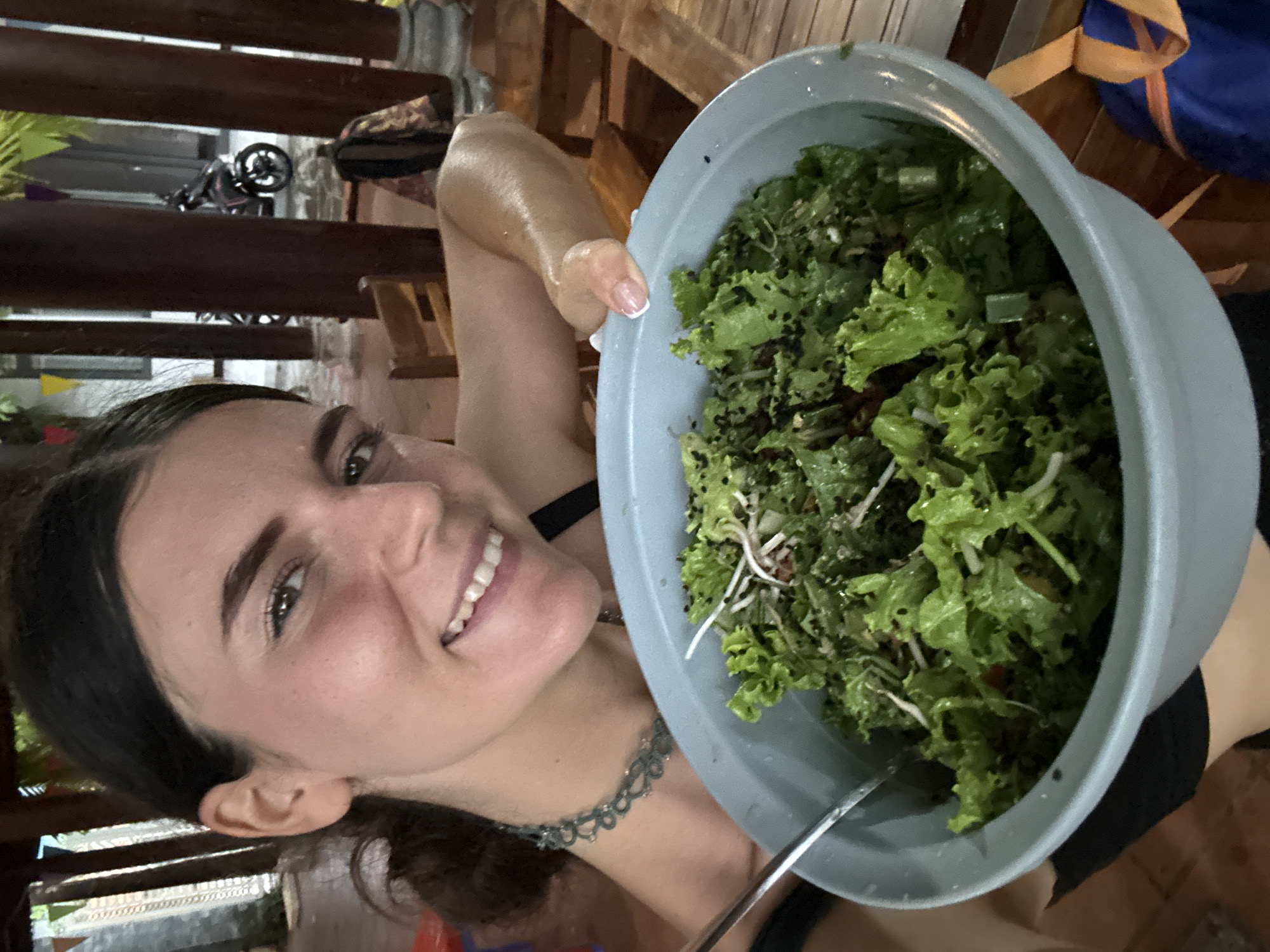 Woman prepares salad, relaxes with kitten in Mũi Né pavilion