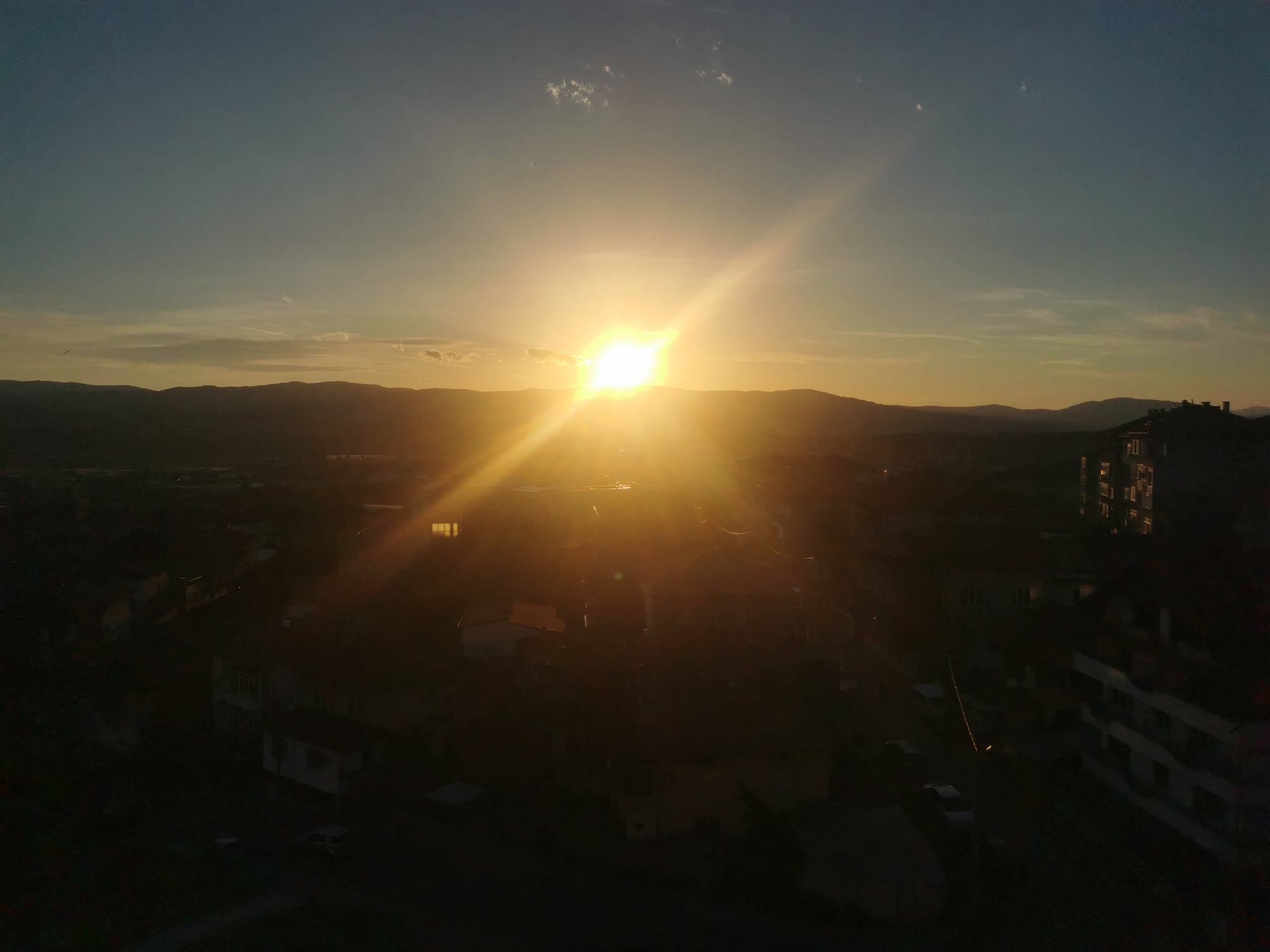 Sunset observed over Blagoevgrad, Bulgaria behind mountain silhouettes