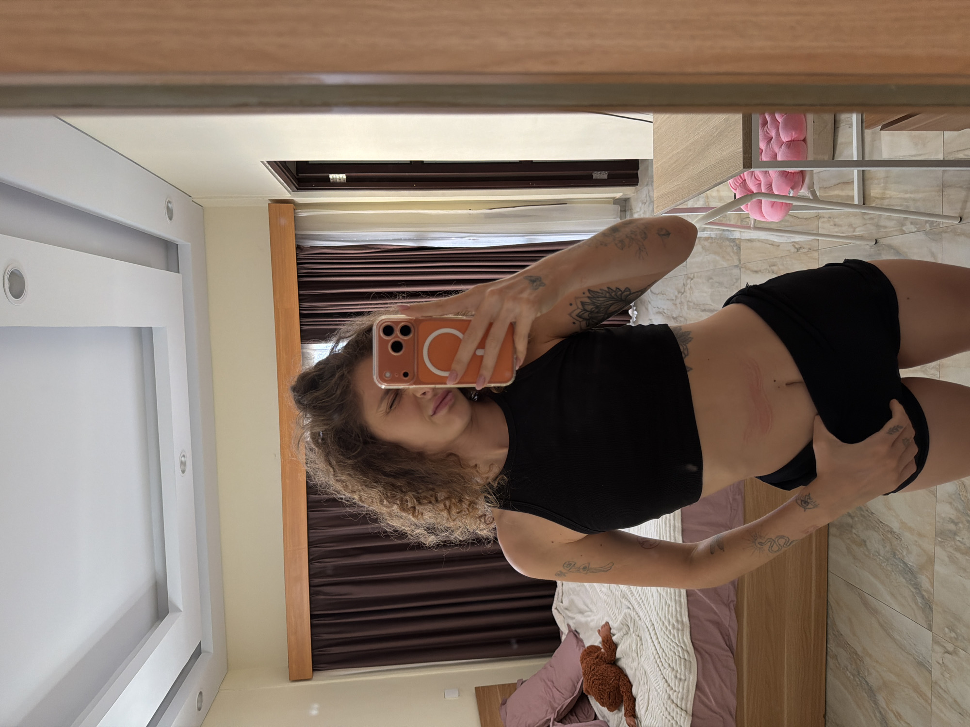 Woman Takes Playful Selfie Session in North Kuta Bedroom