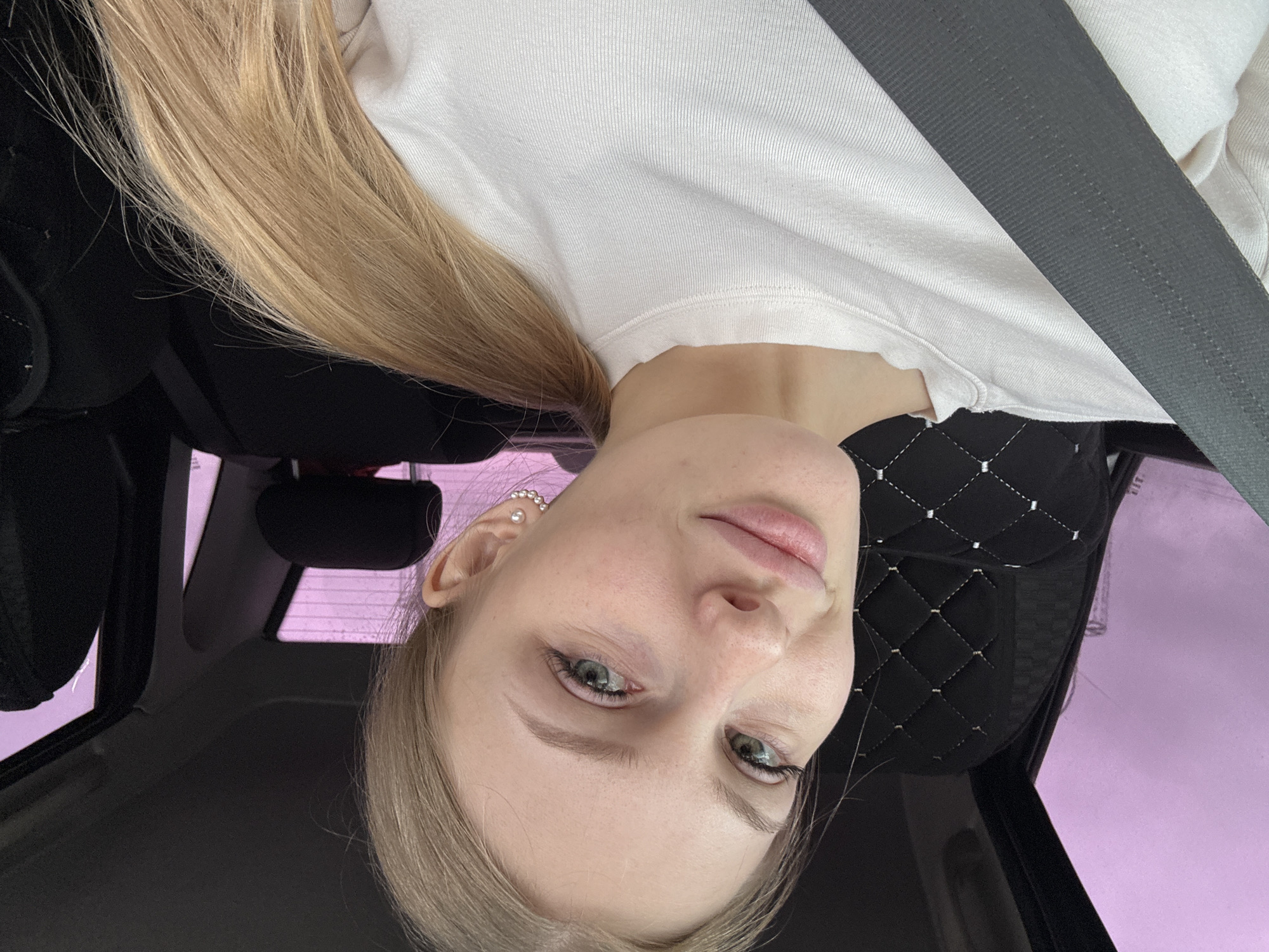 Woman photographed in car during afternoon drive in Perm