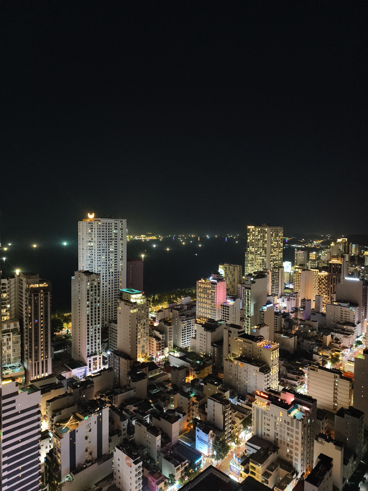 Rooftop bar scenes captured overlooking illuminated coastal city