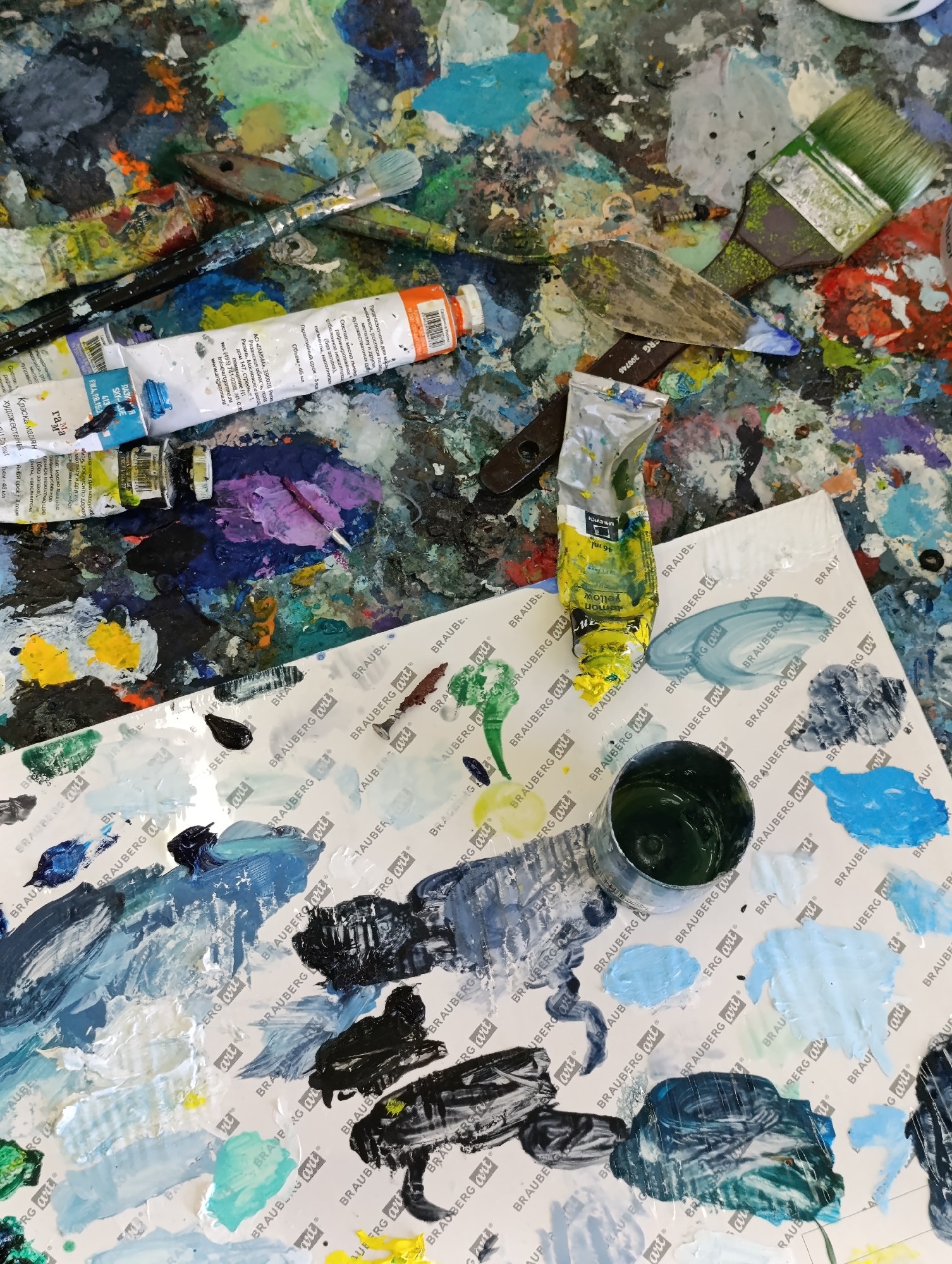 Artist workspace and hand-held painting documented in Tara, Russia