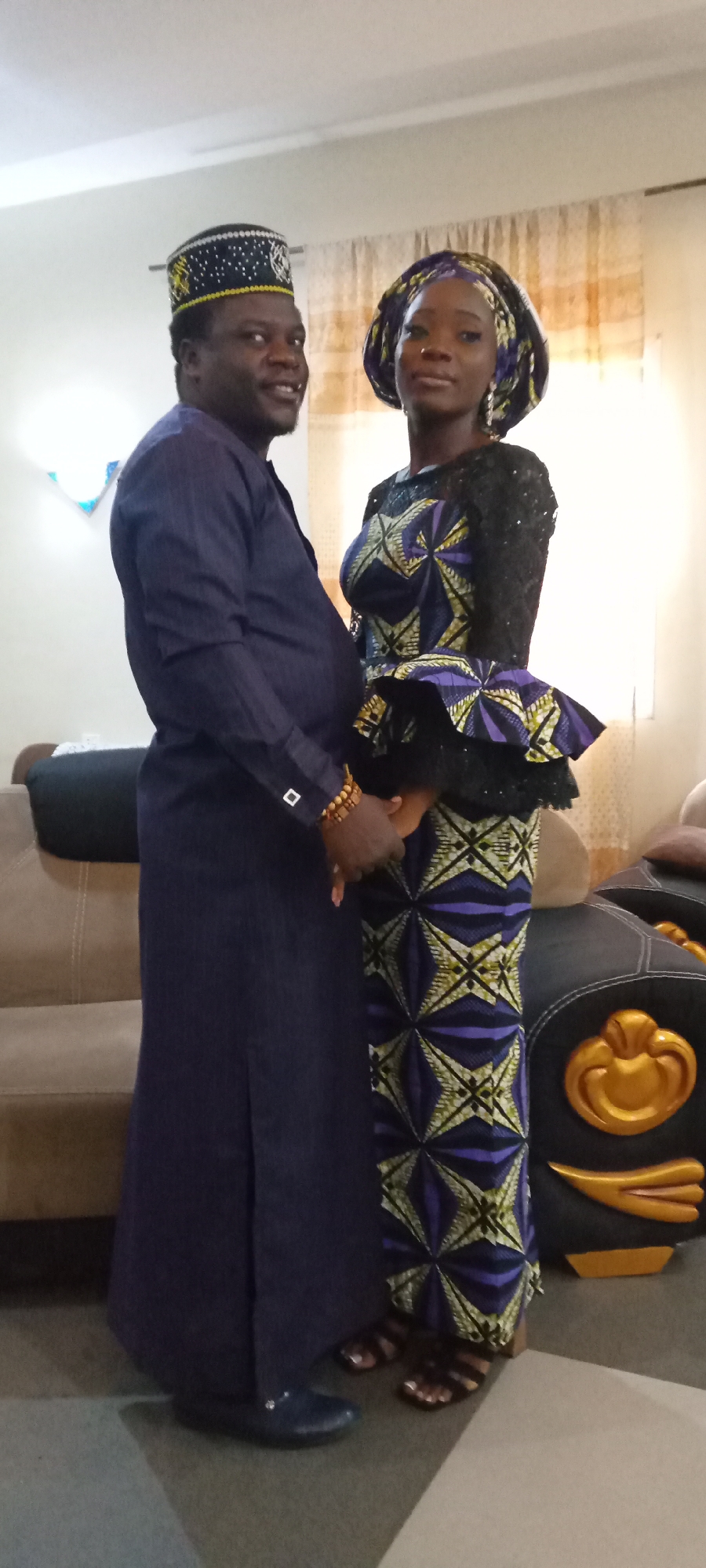 Couple in traditional attire share intimate moments indoors