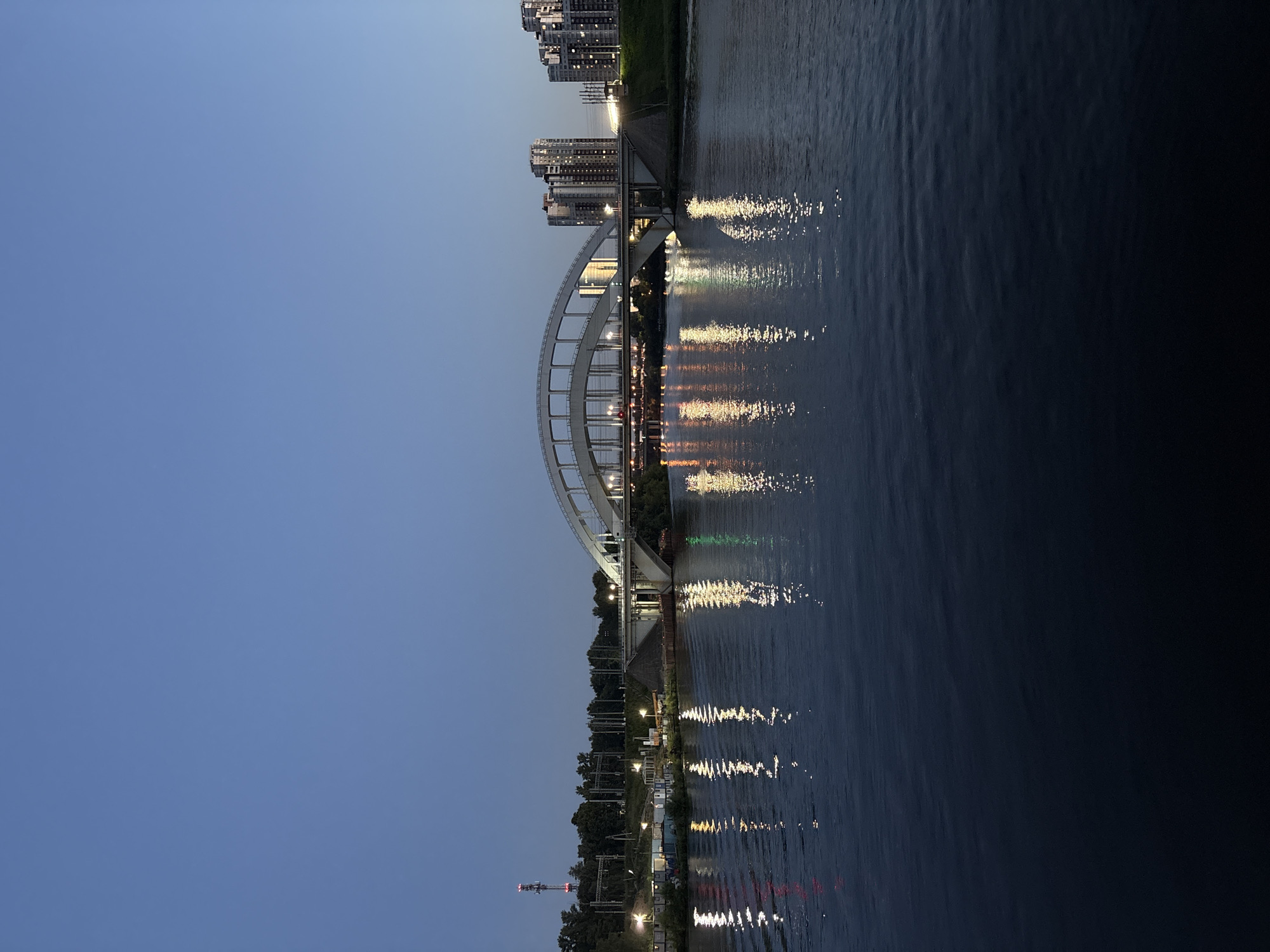 Arched bridge over a wide river at blue hour, Khimki