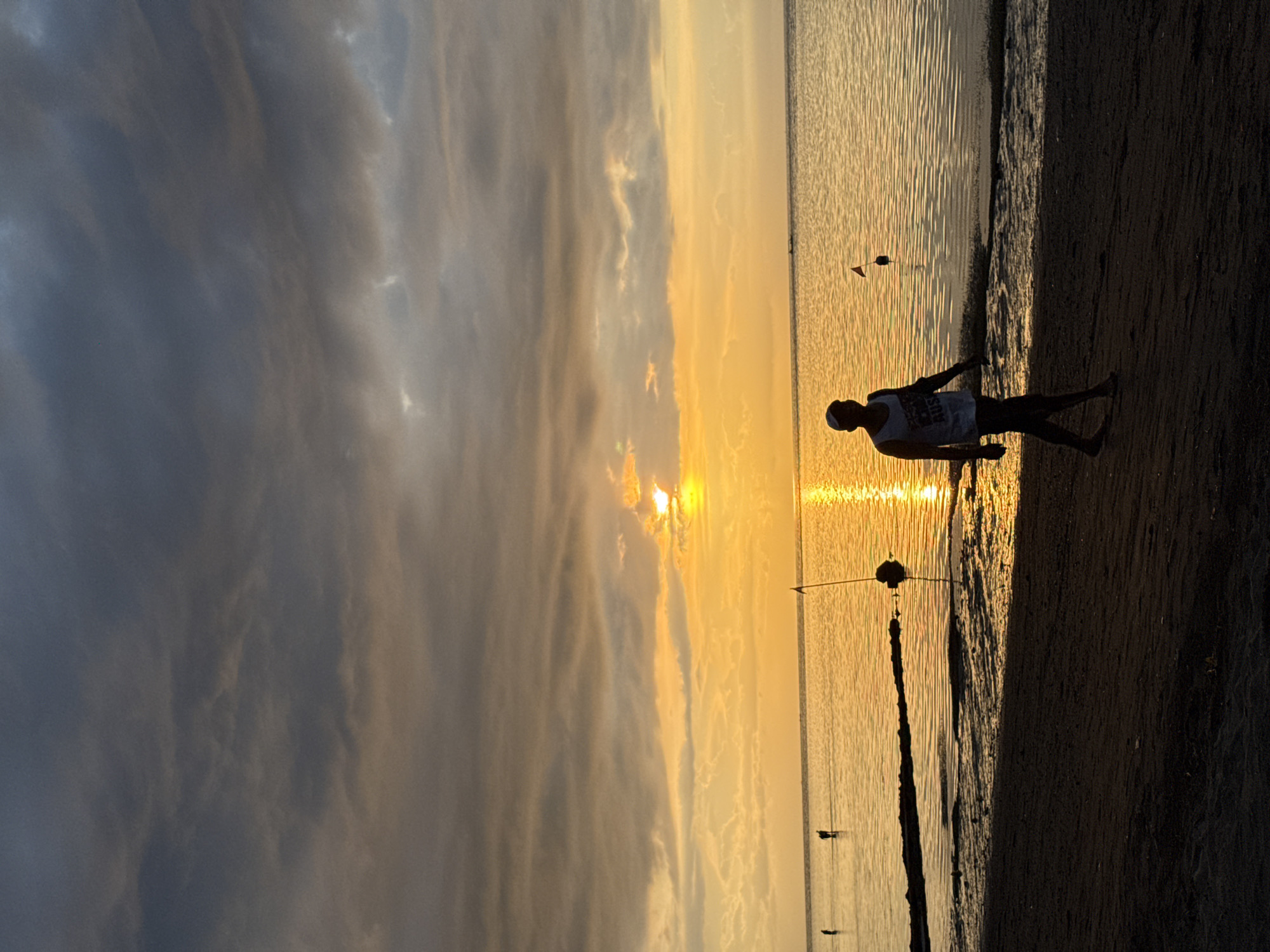 Evening beach gathering documented during sunset in Buleleng, Indonesia