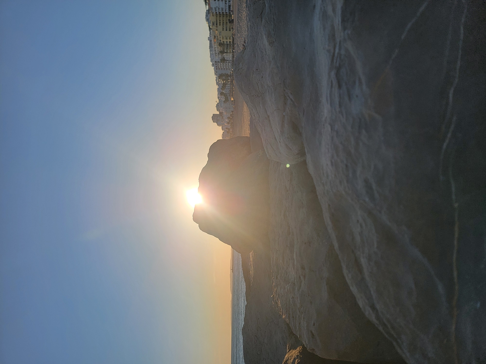 Quarteira coastline at golden hour — rocks, sunset, beach life