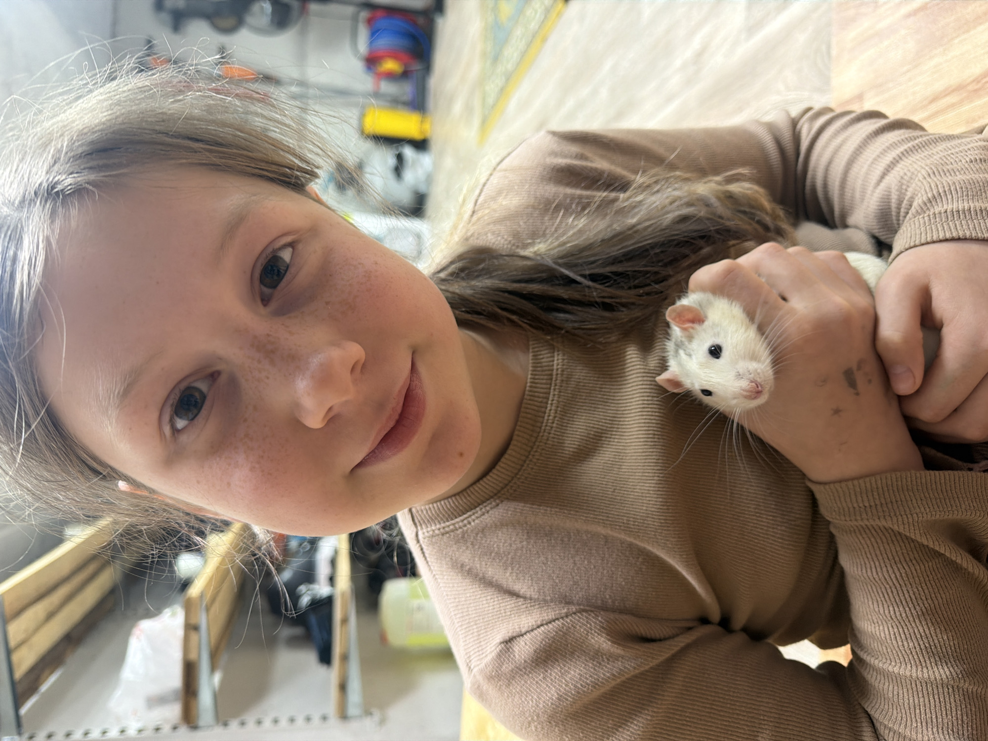 Child and woman play with pet rat in Markovo home