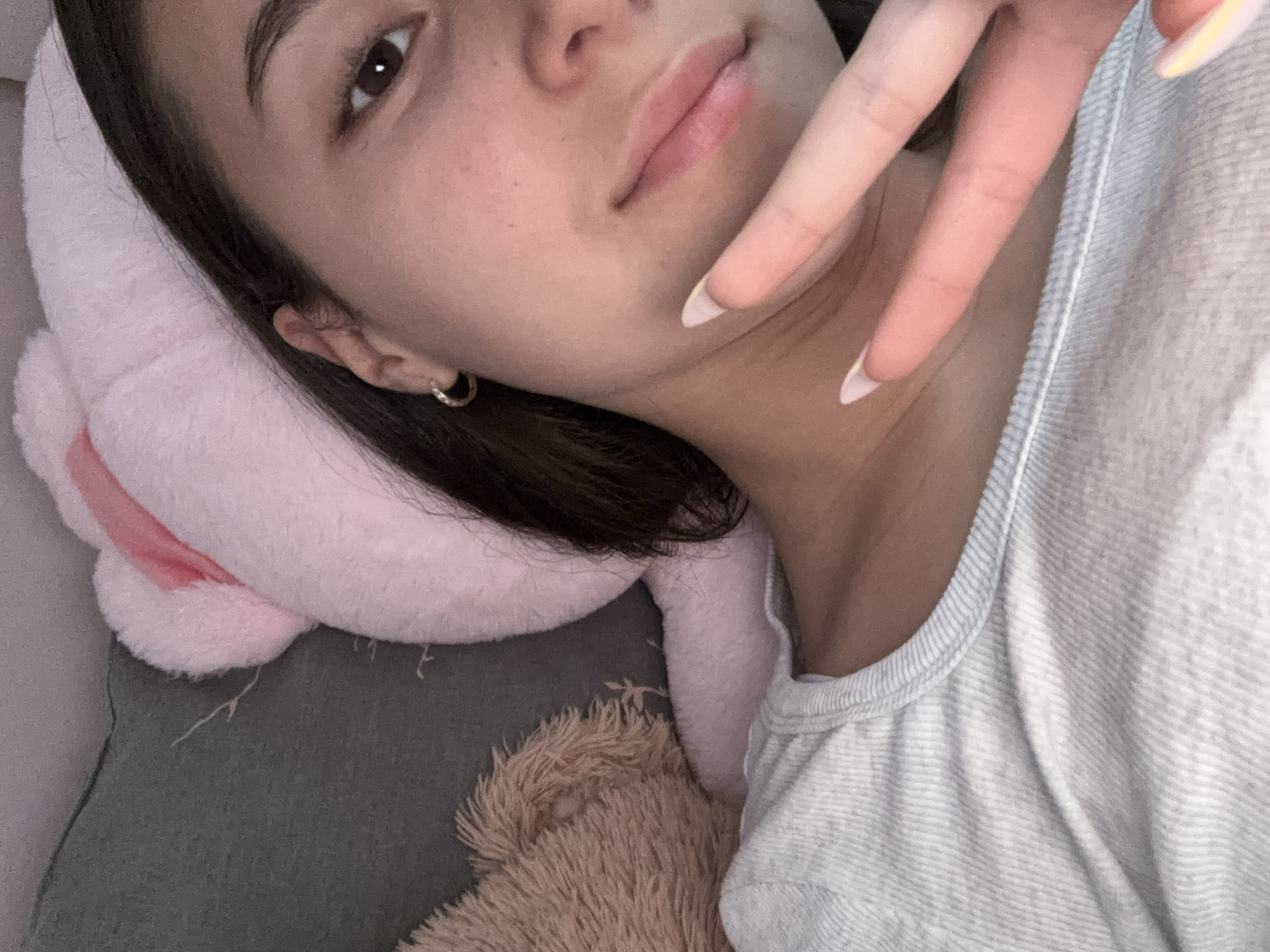 Woman makes peace sign gesture while resting indoors in Bulgaria