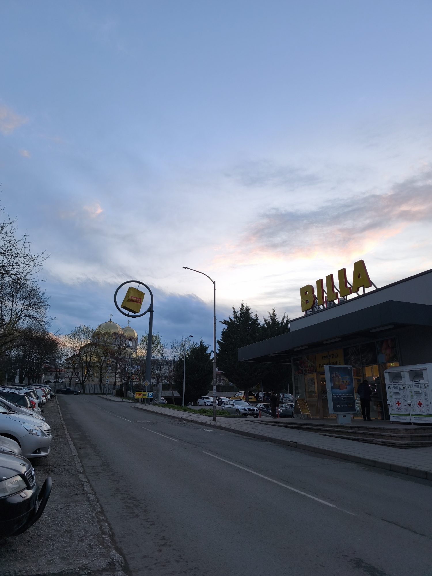 Evening street activity observed near Billa supermarket in Burgas