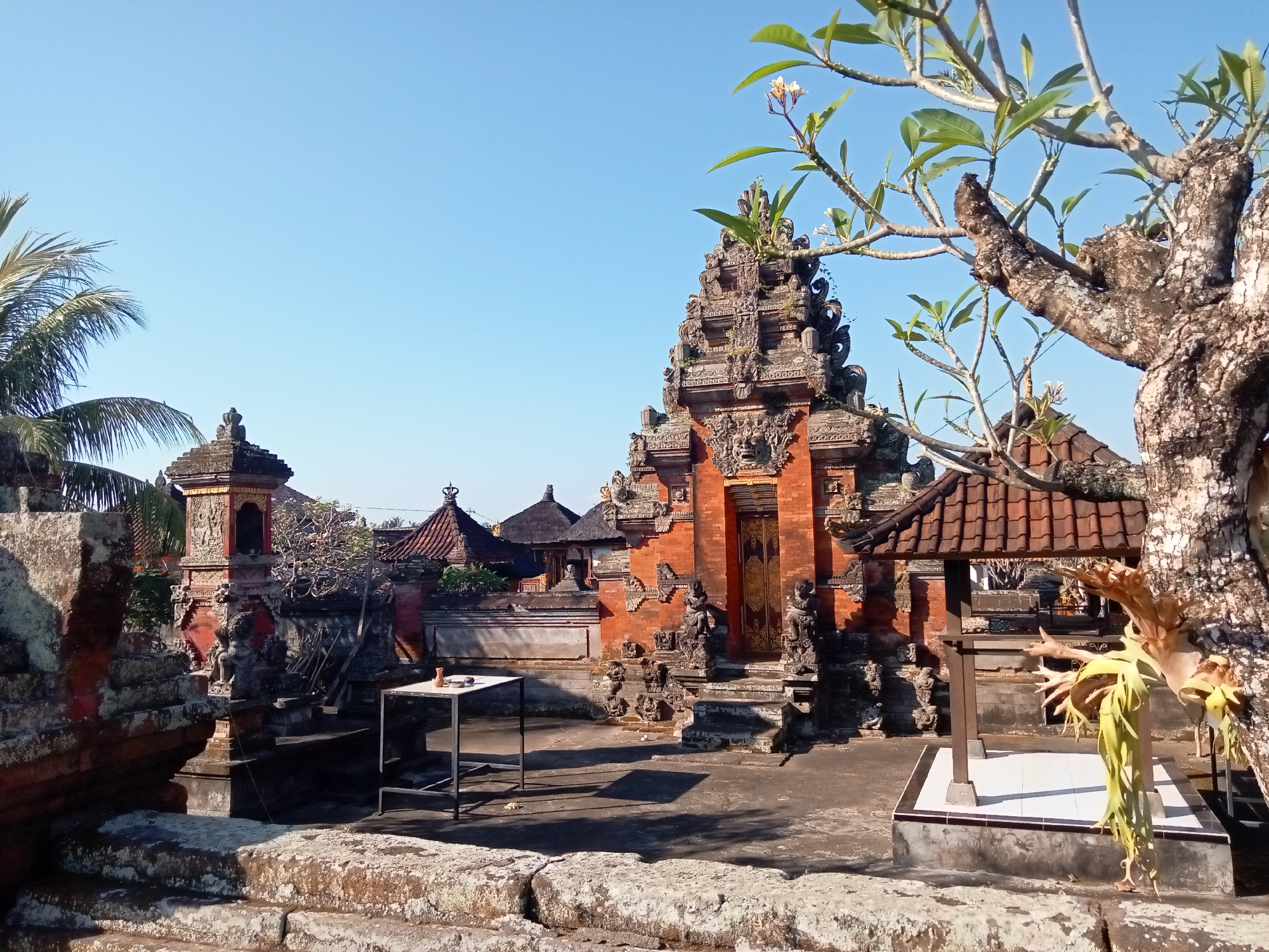 Hindu temple complex observed with ornate red brick gate