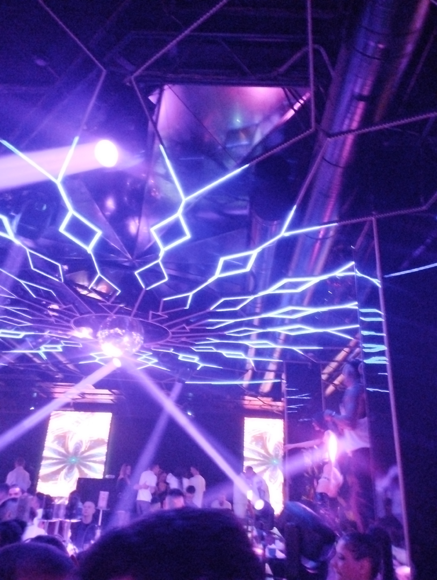 Early morning nightclub scene captured with purple lighting, disco ball