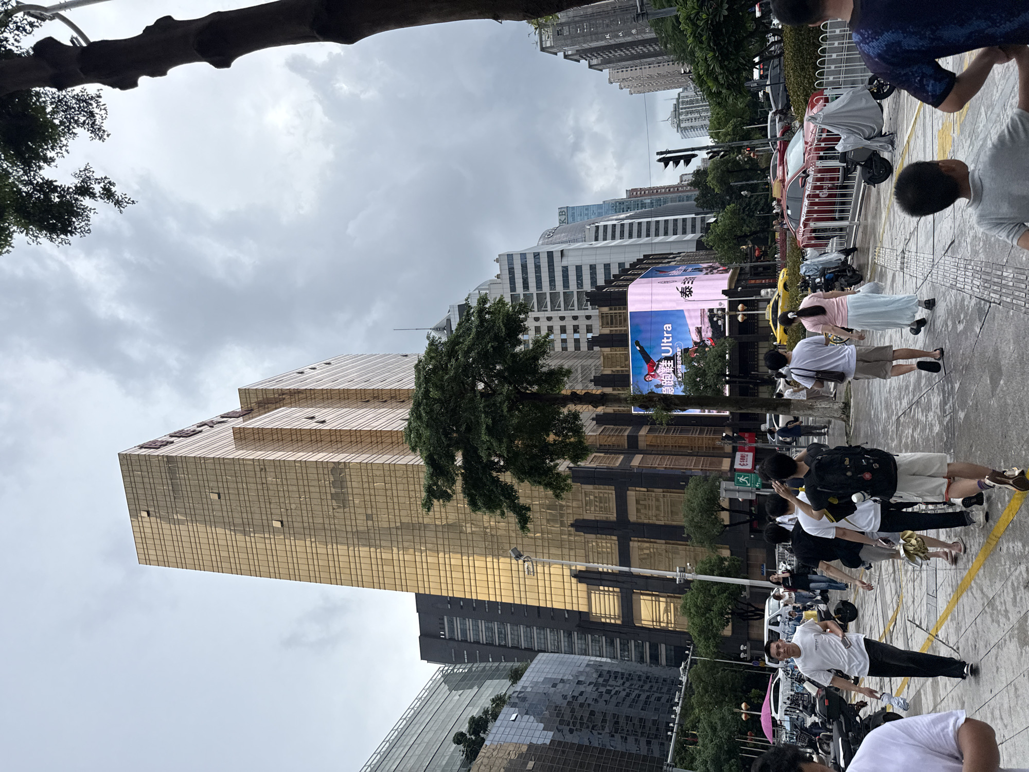 Busy morning streets in Guangzhou's Tianhe District under grey skies