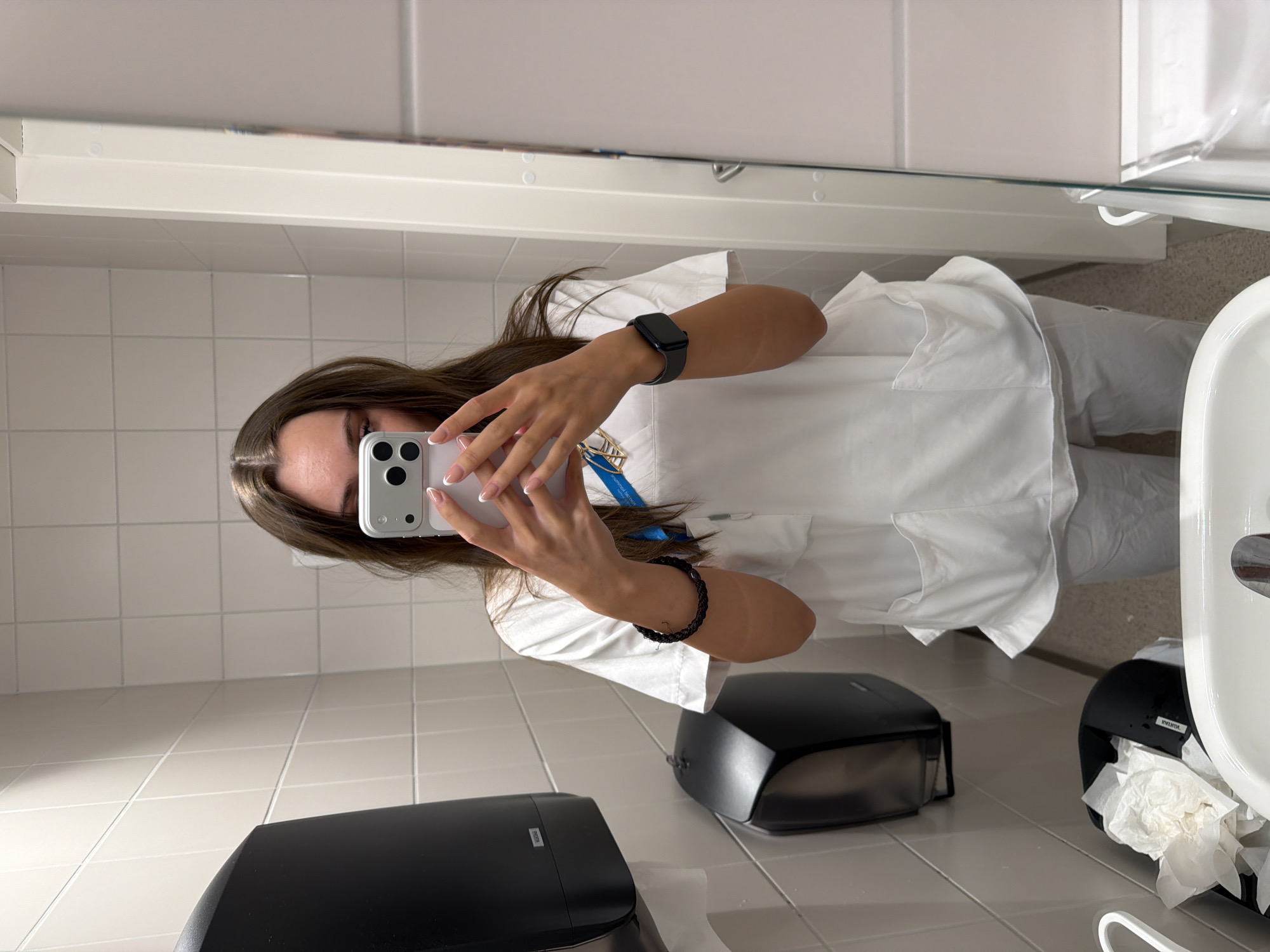 Mirror selfie in white medical scrubs, Harstad bathroom