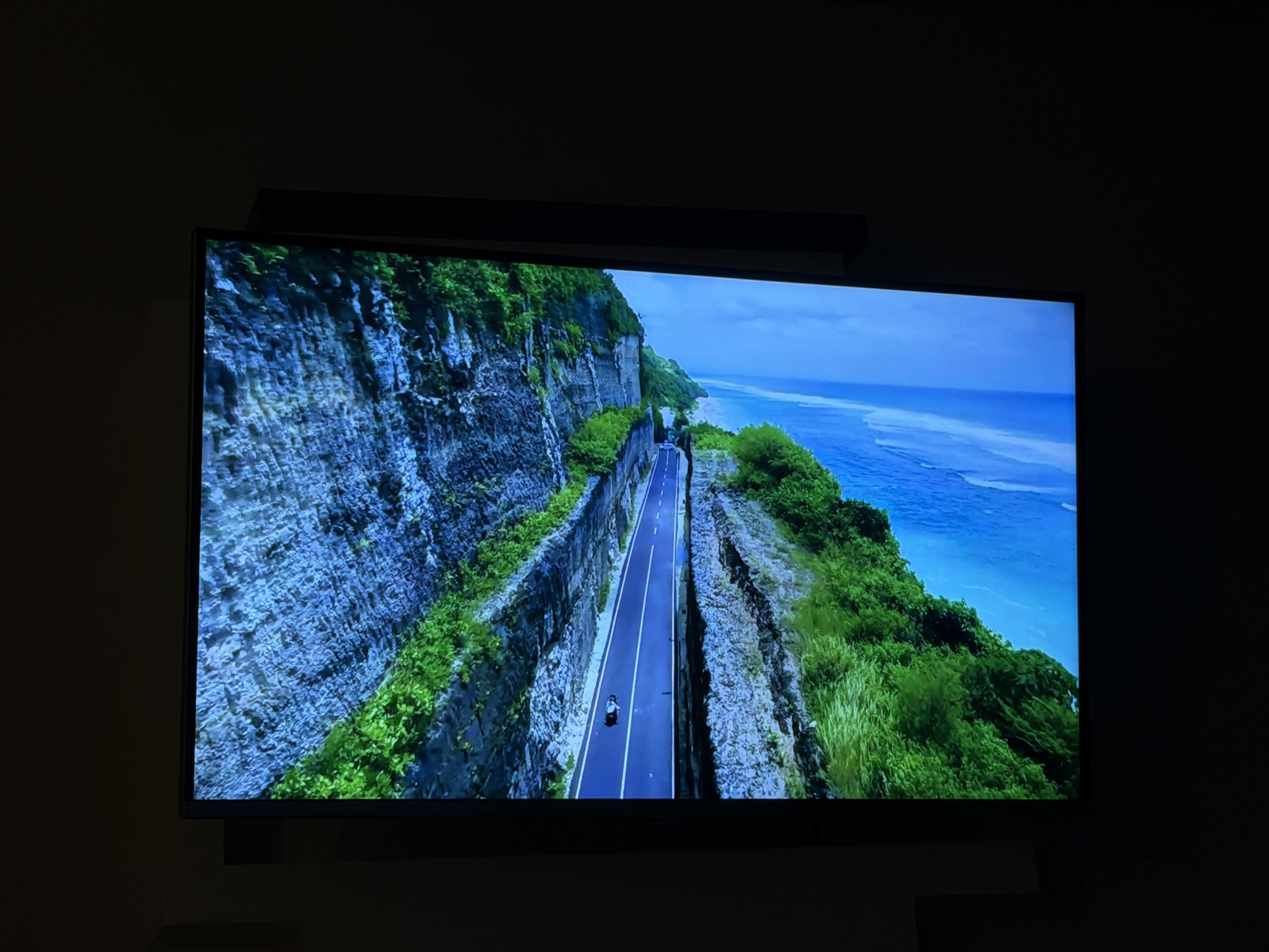 Apartment evening in Mahilyow, TV cycling through nature screensavers