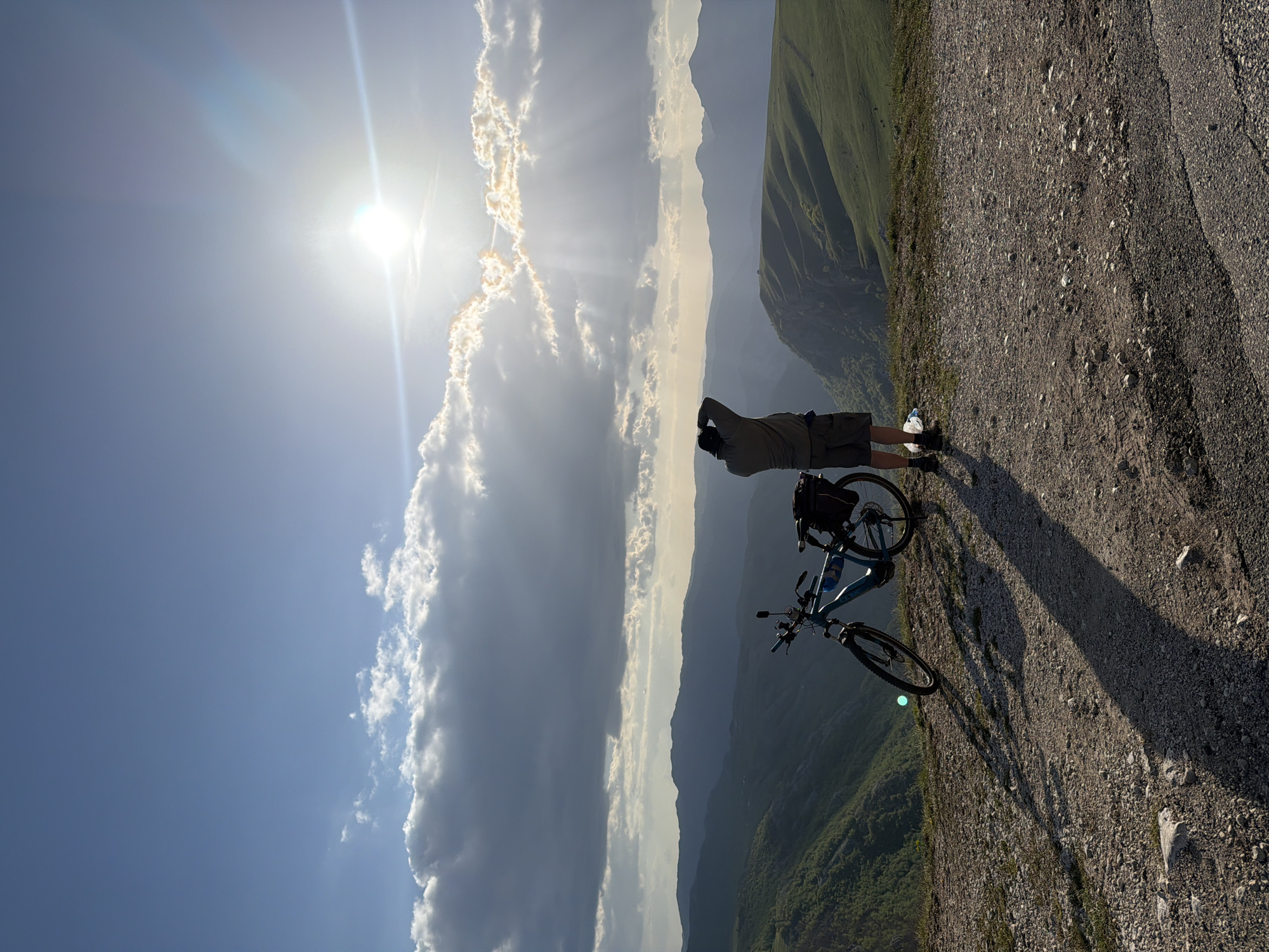 Cyclist pauses for mountain views in sunny Montenegro