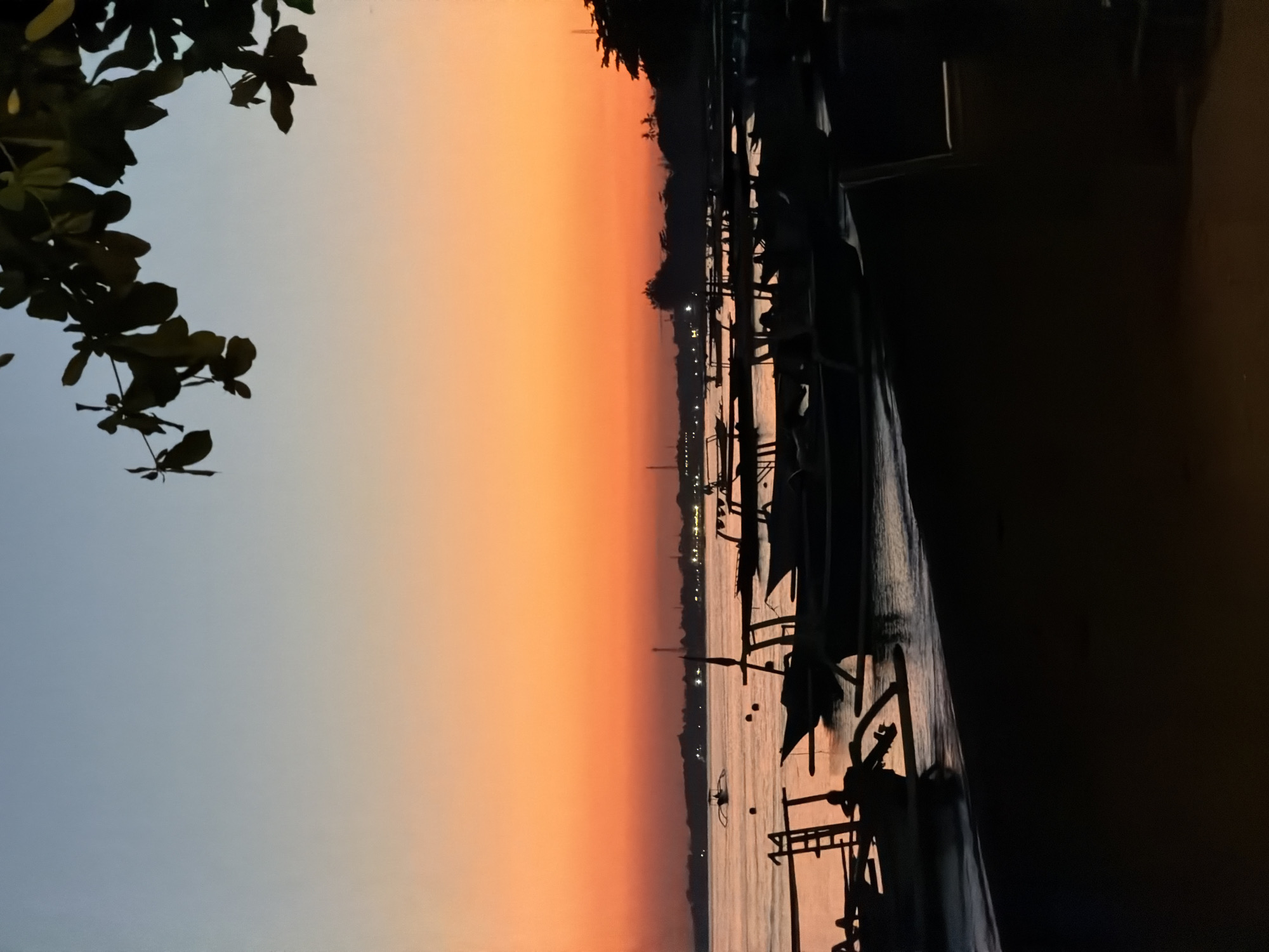 Fishing boats line the Buleleng shore at sunset