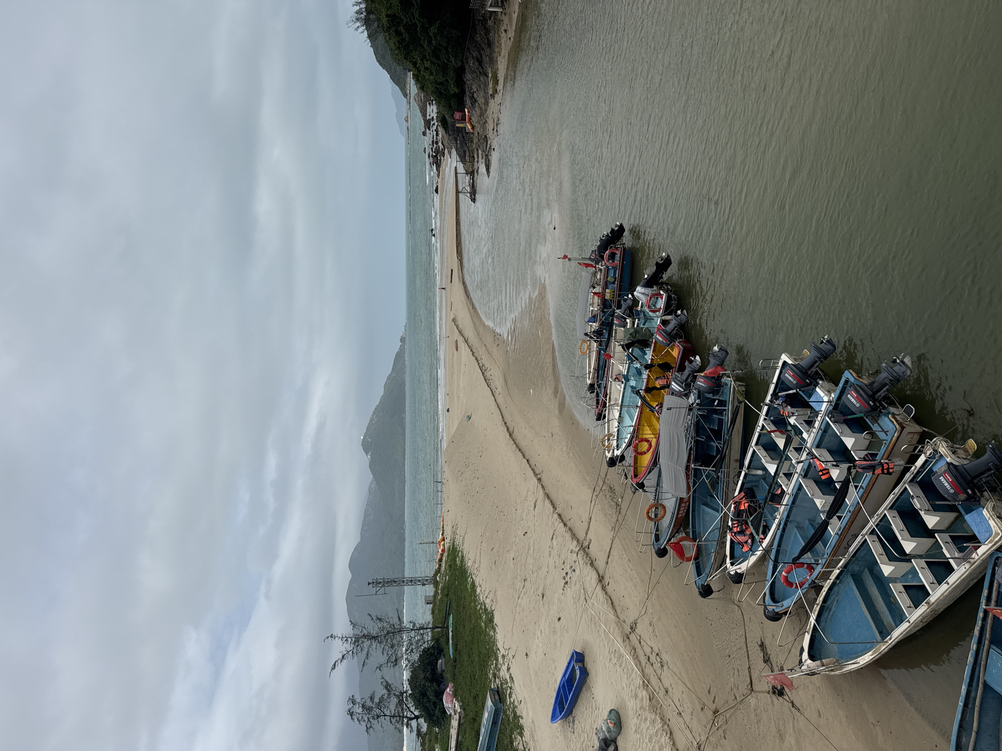 Blue fishing boats moored along waterway in Longgang District
