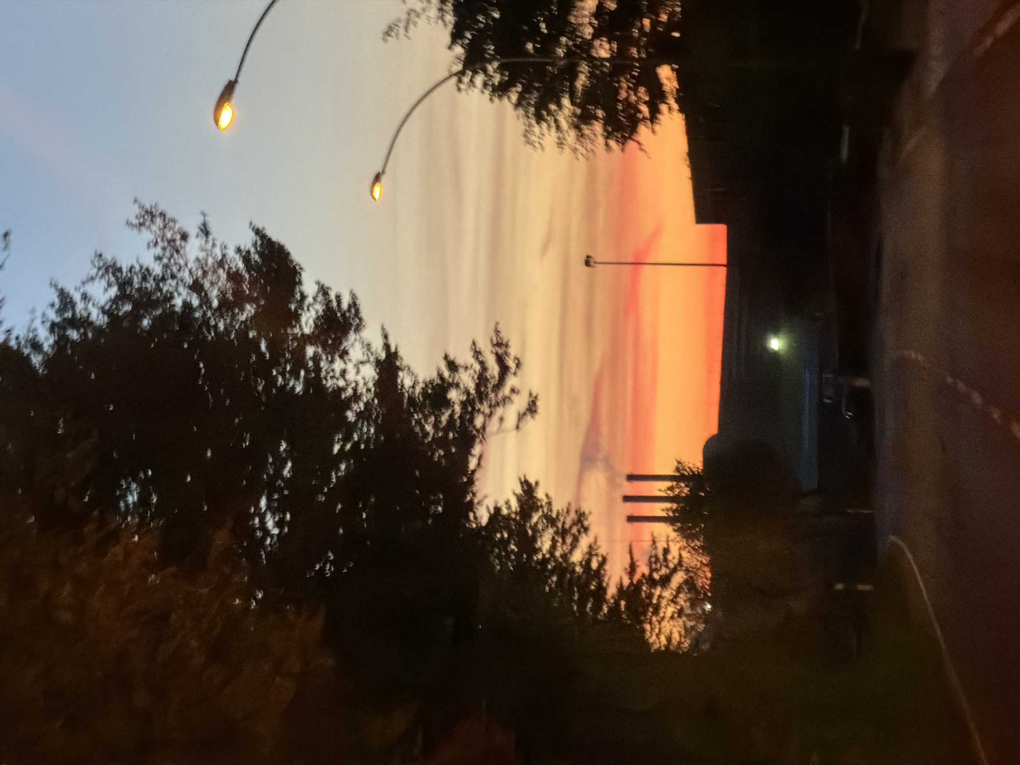 Sunset observed in Leudelange, Luxembourg with illuminated street scene