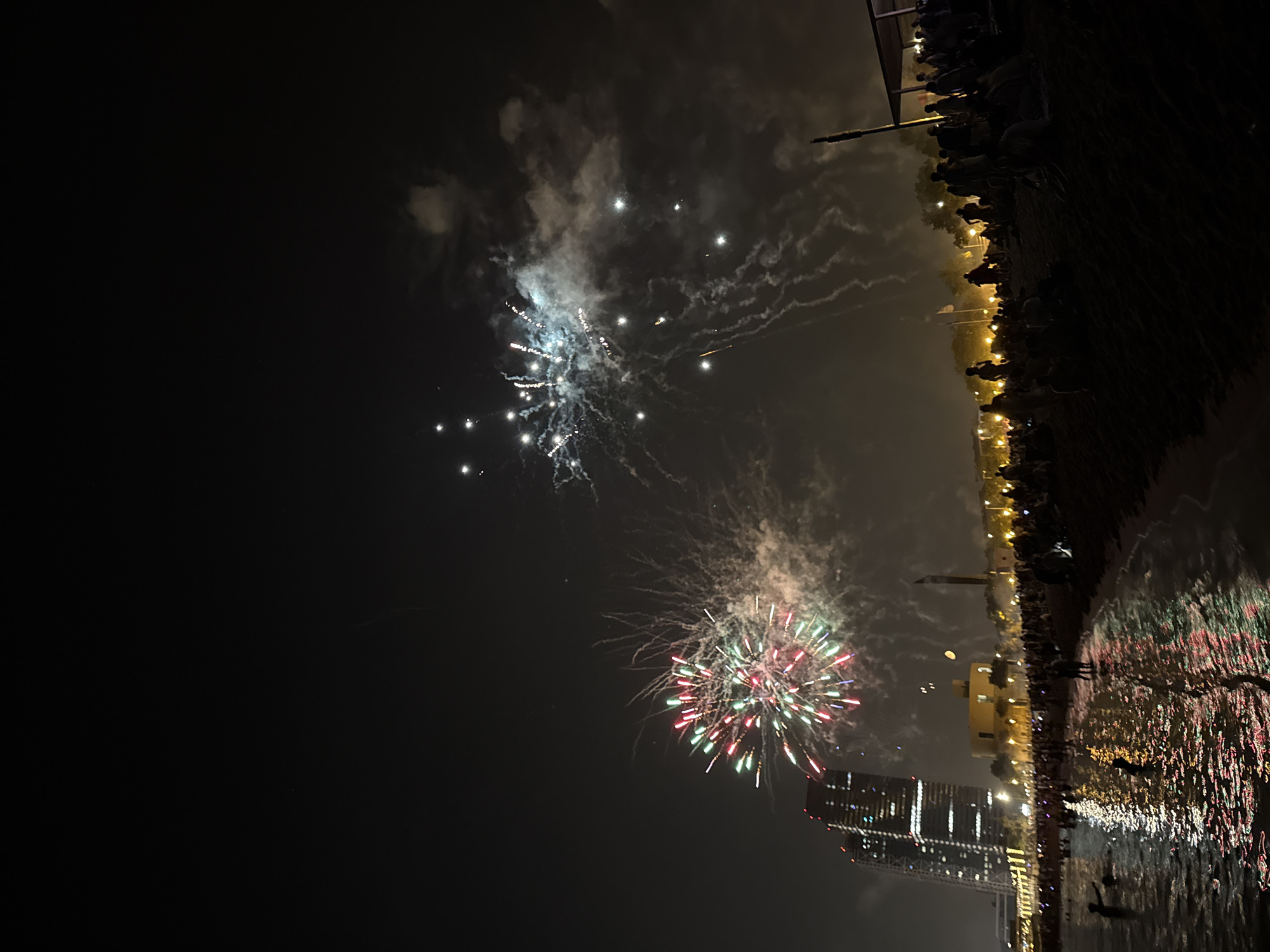 Barcelona's Sant Joan night: beach crowds, fireworks, sea.