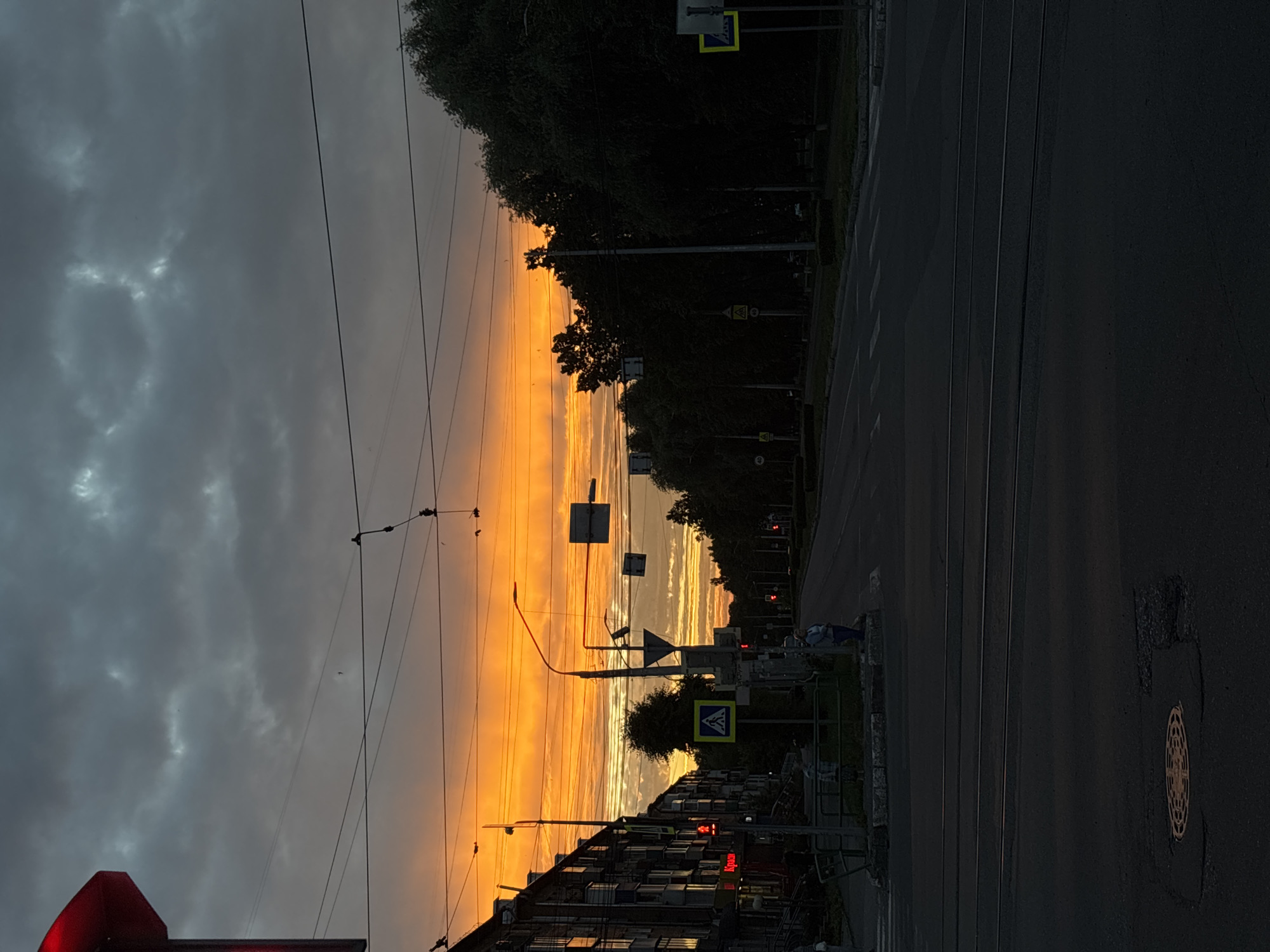 Novokuznetsk tram street glows under a vivid summer sunset