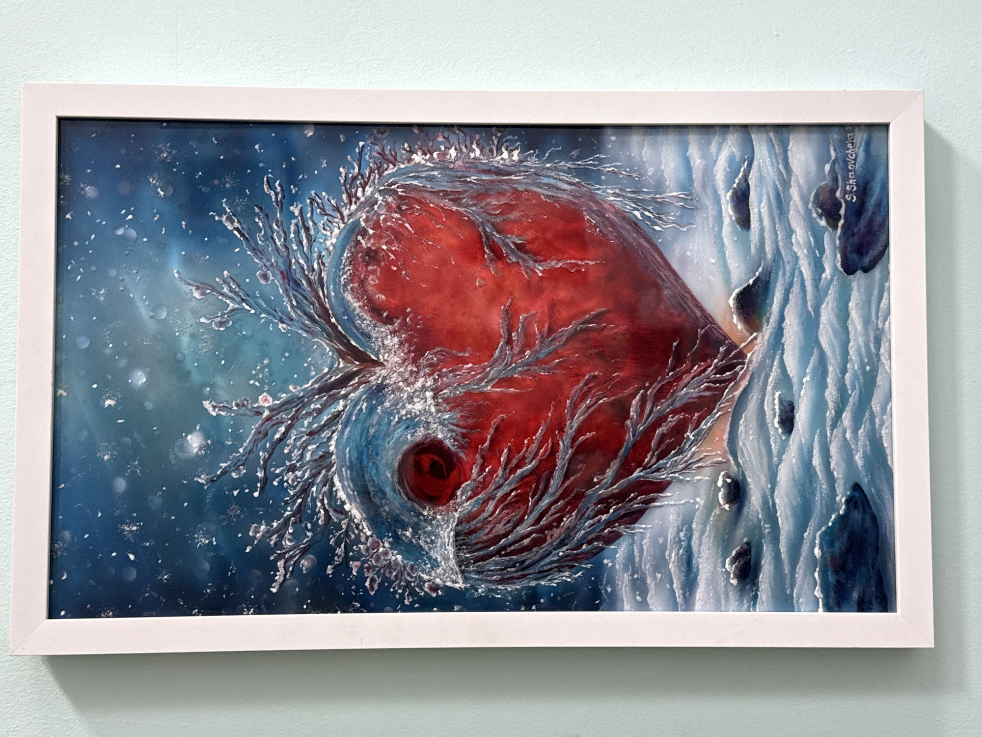 Art display with heart painting and nail competition trophy observed