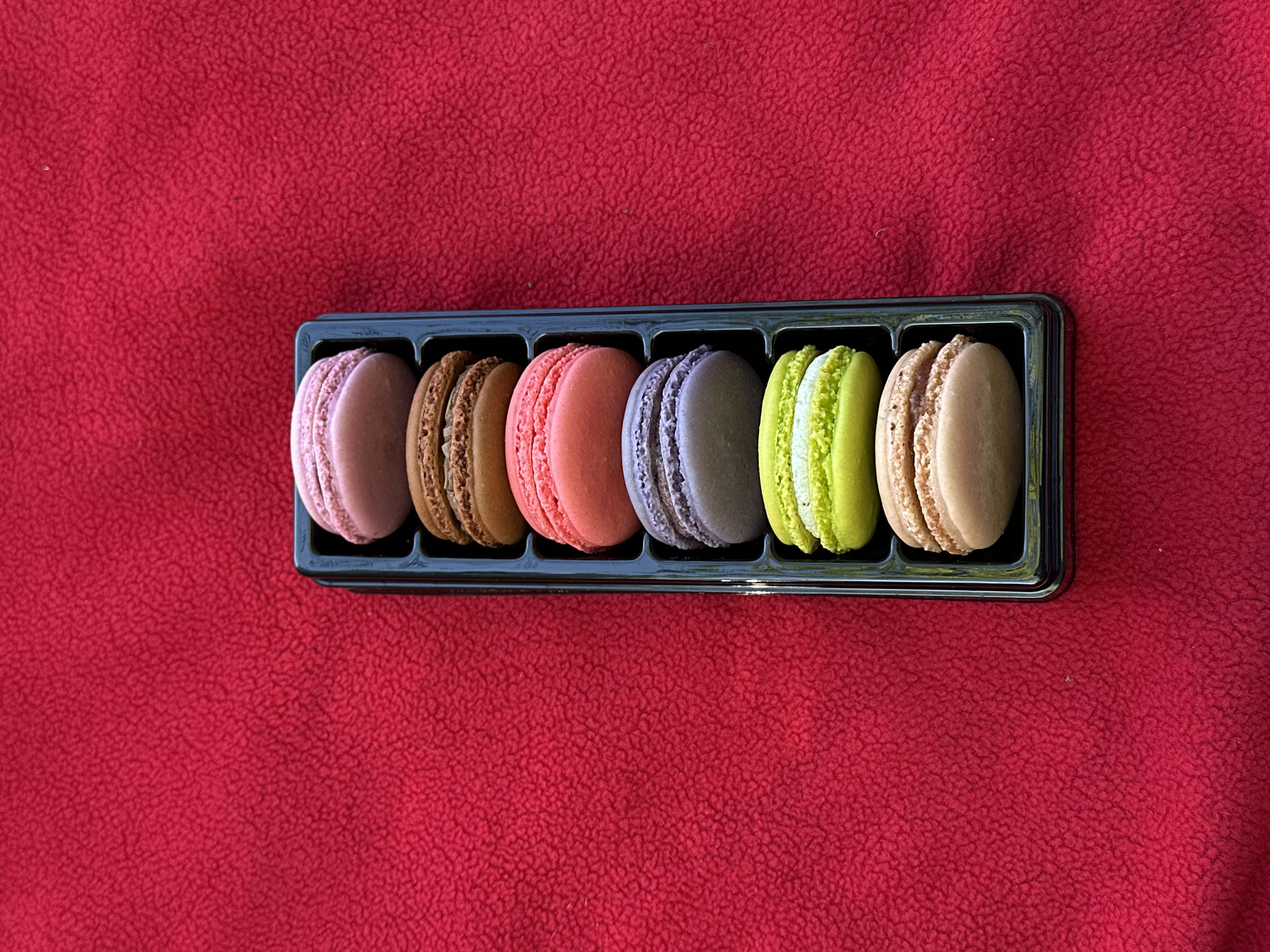 Colorful macarons displayed on blanket in Port Moody