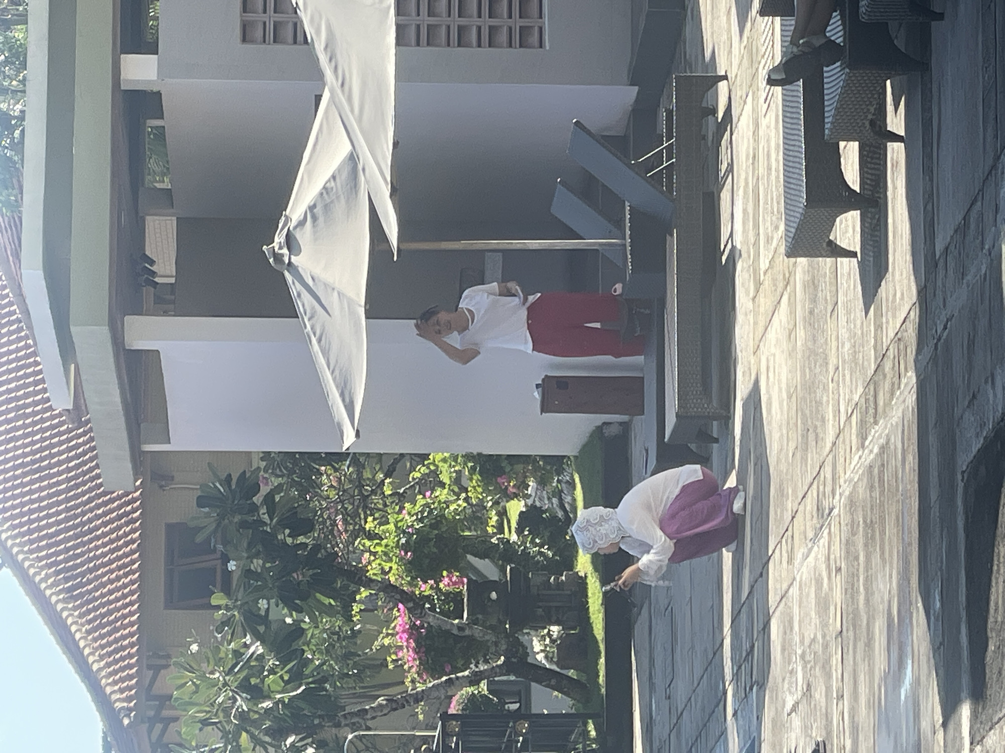 Resort pool day in Kuta Selatan, kids swimming, adults relaxing