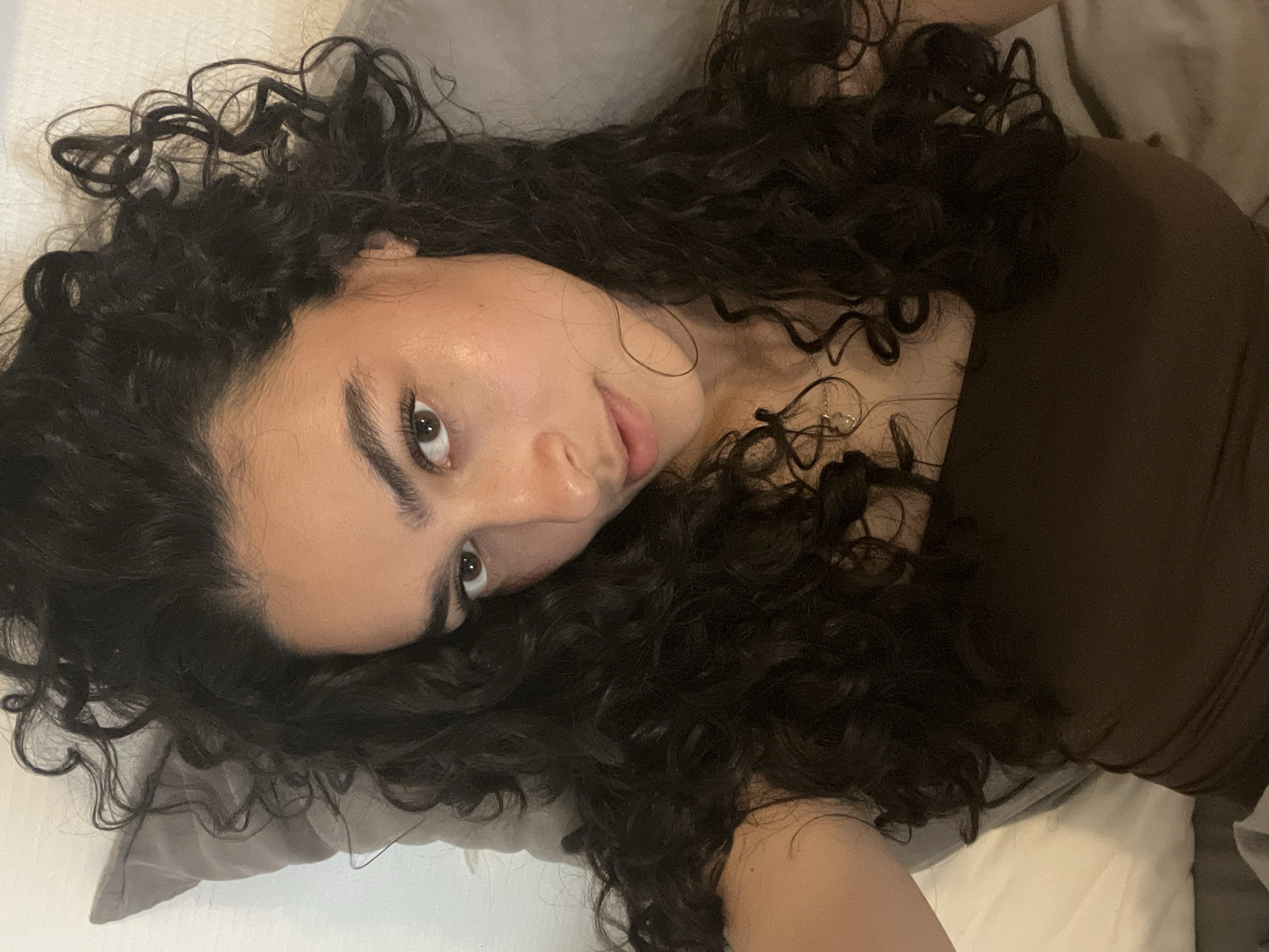 Woman resting on pillow observed in Lyon bedroom
