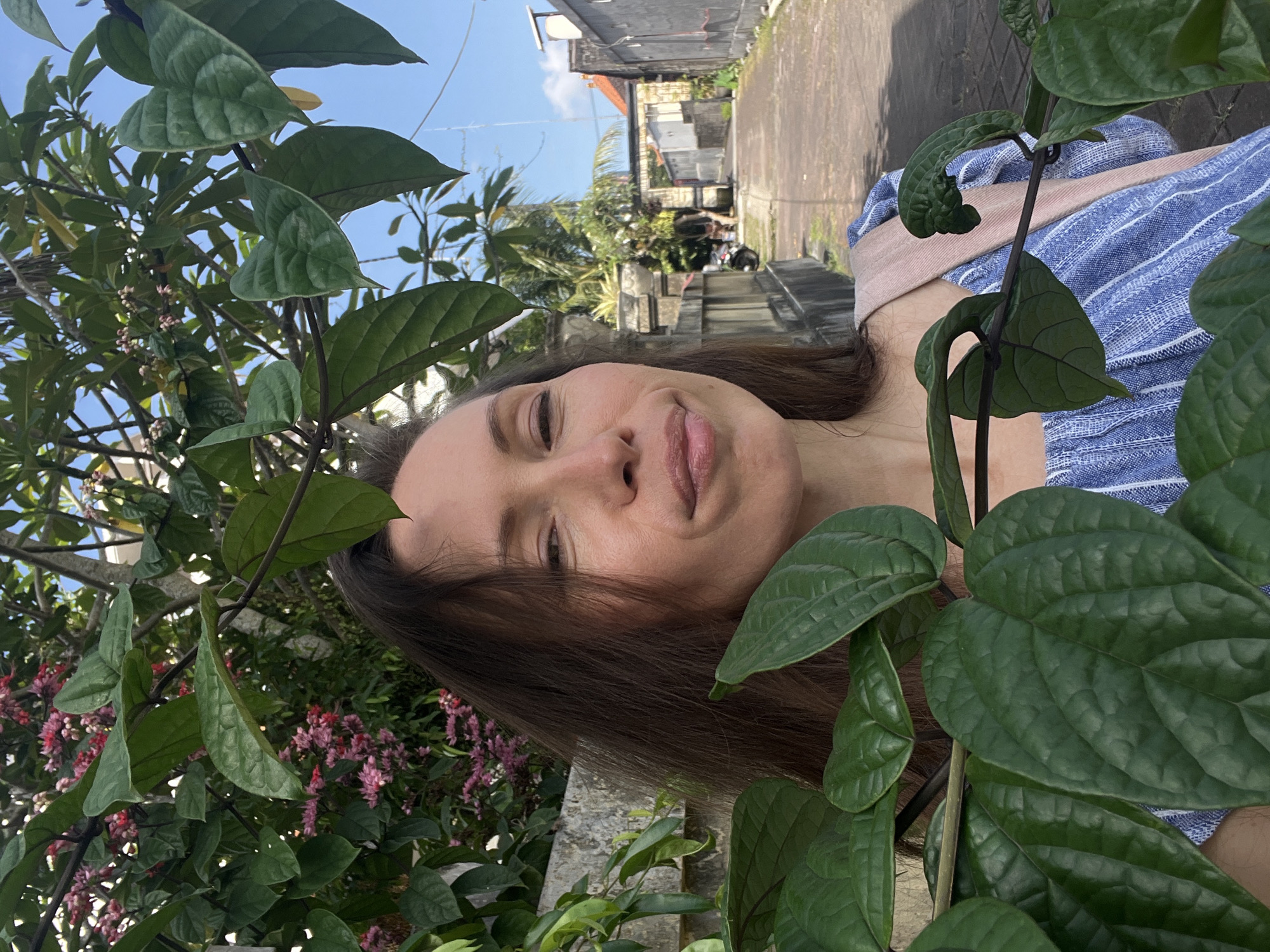 Woman takes morning selfie in North Kuta alleyway