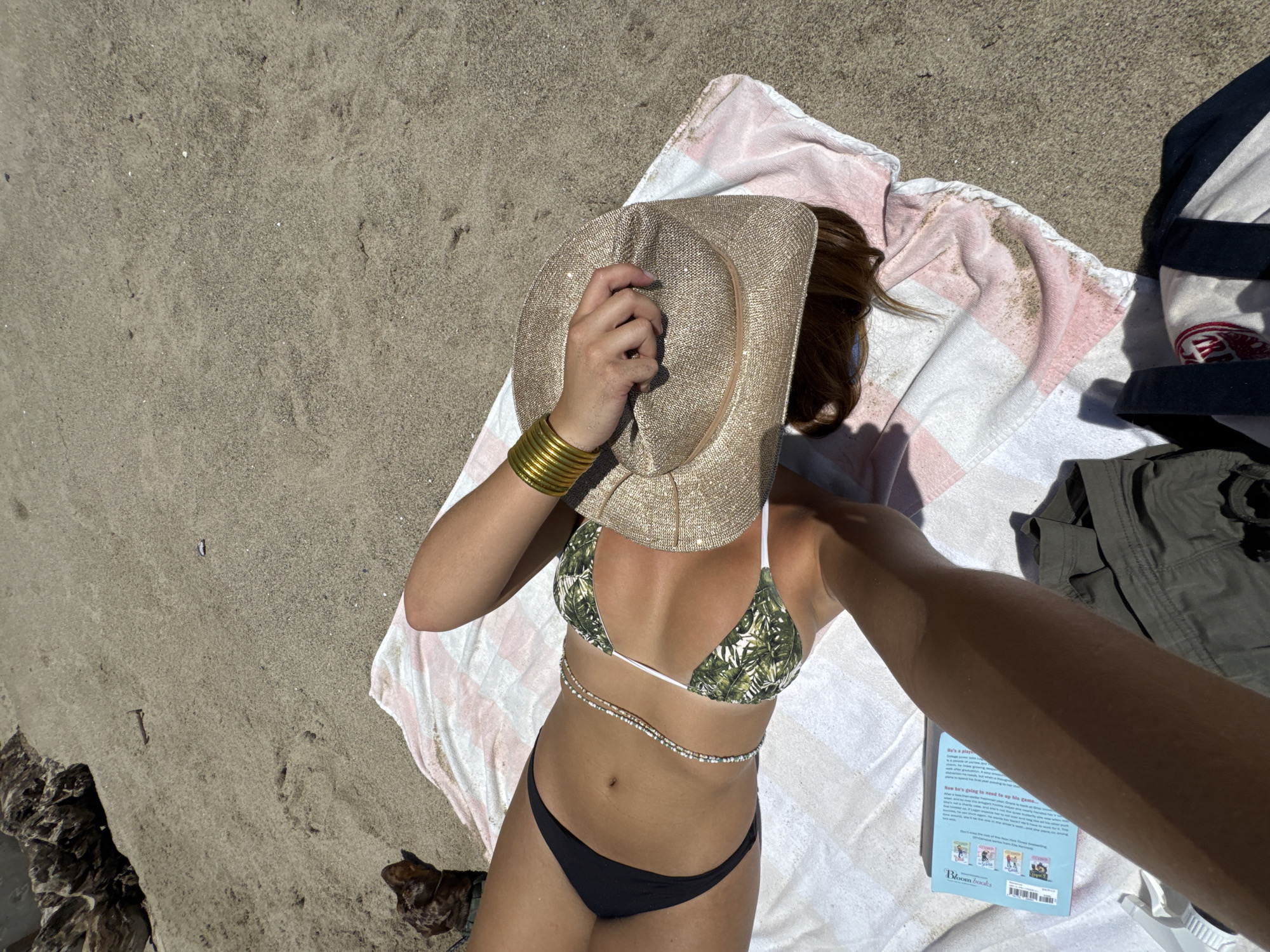Surfers and sunbathers on a Malibu beach afternoon