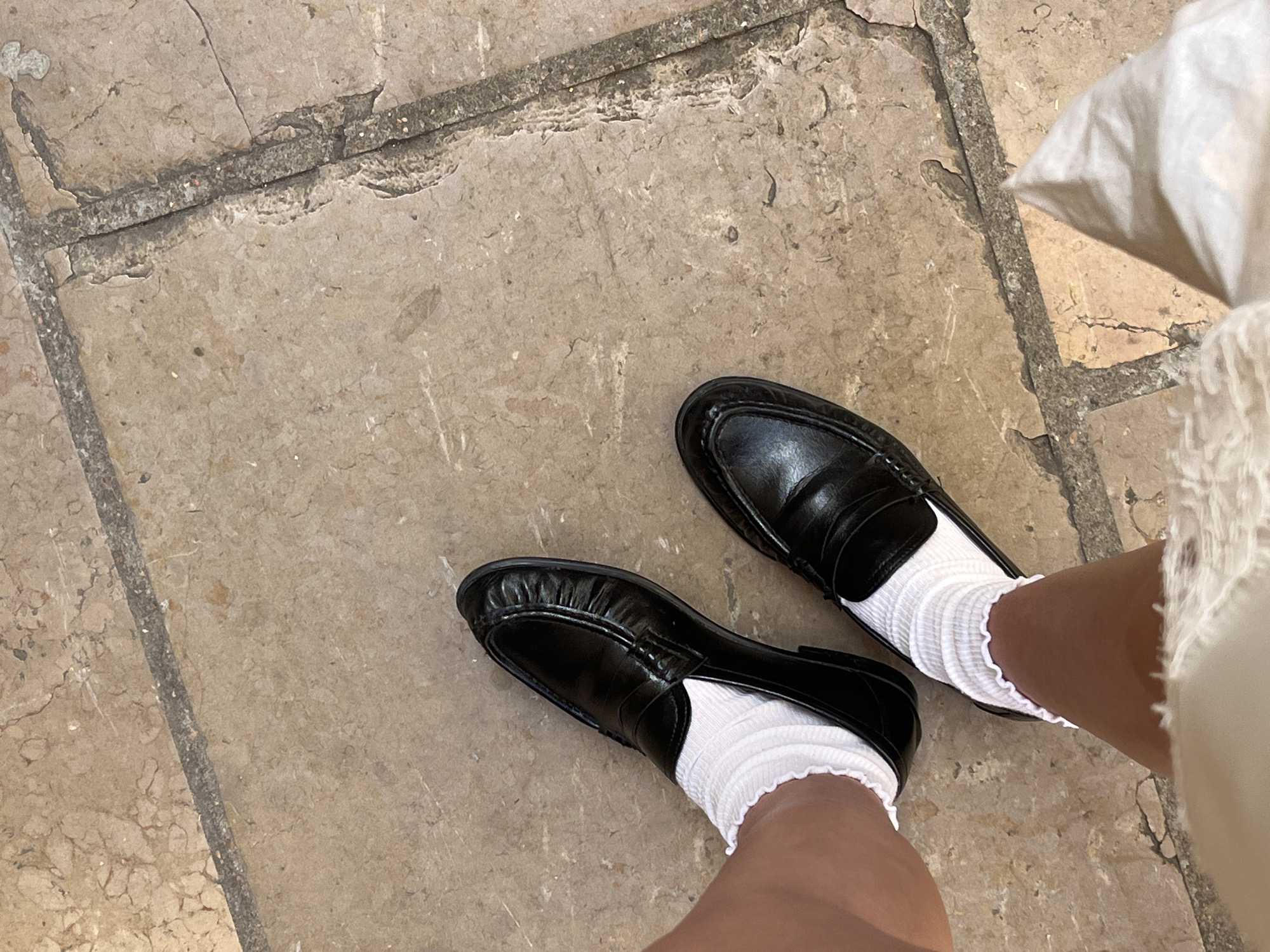 Person in distinctive footwear spotted near antique clock in Lyon