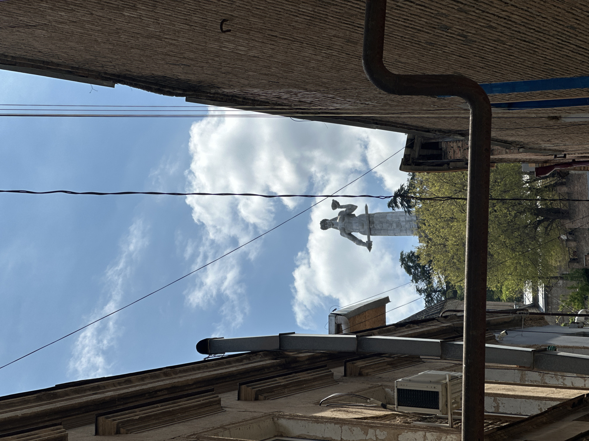 Tourist documents morning walk through historic Tbilisi streets