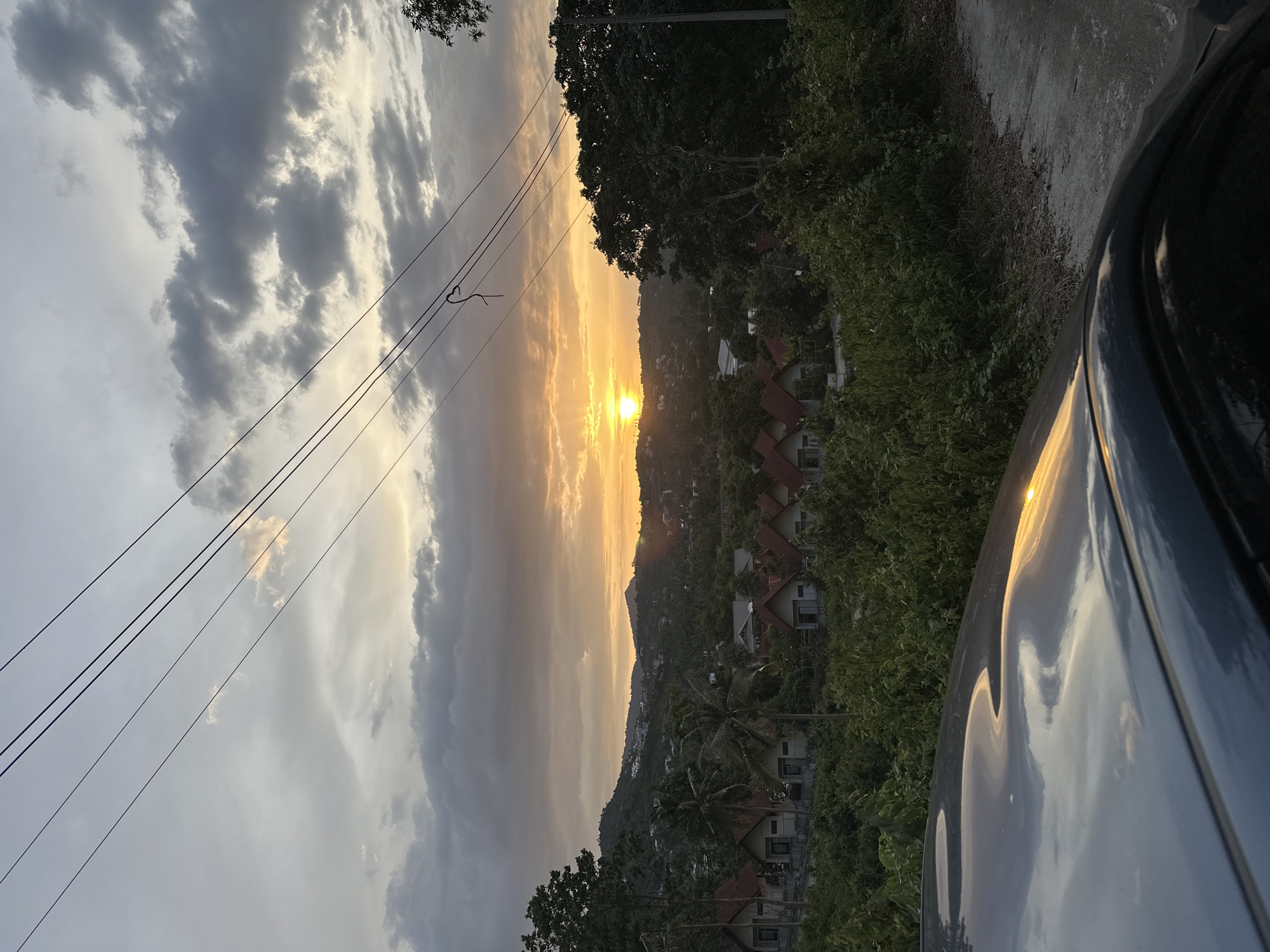 Sunset over Ko Samui's hills, shot from a moving car