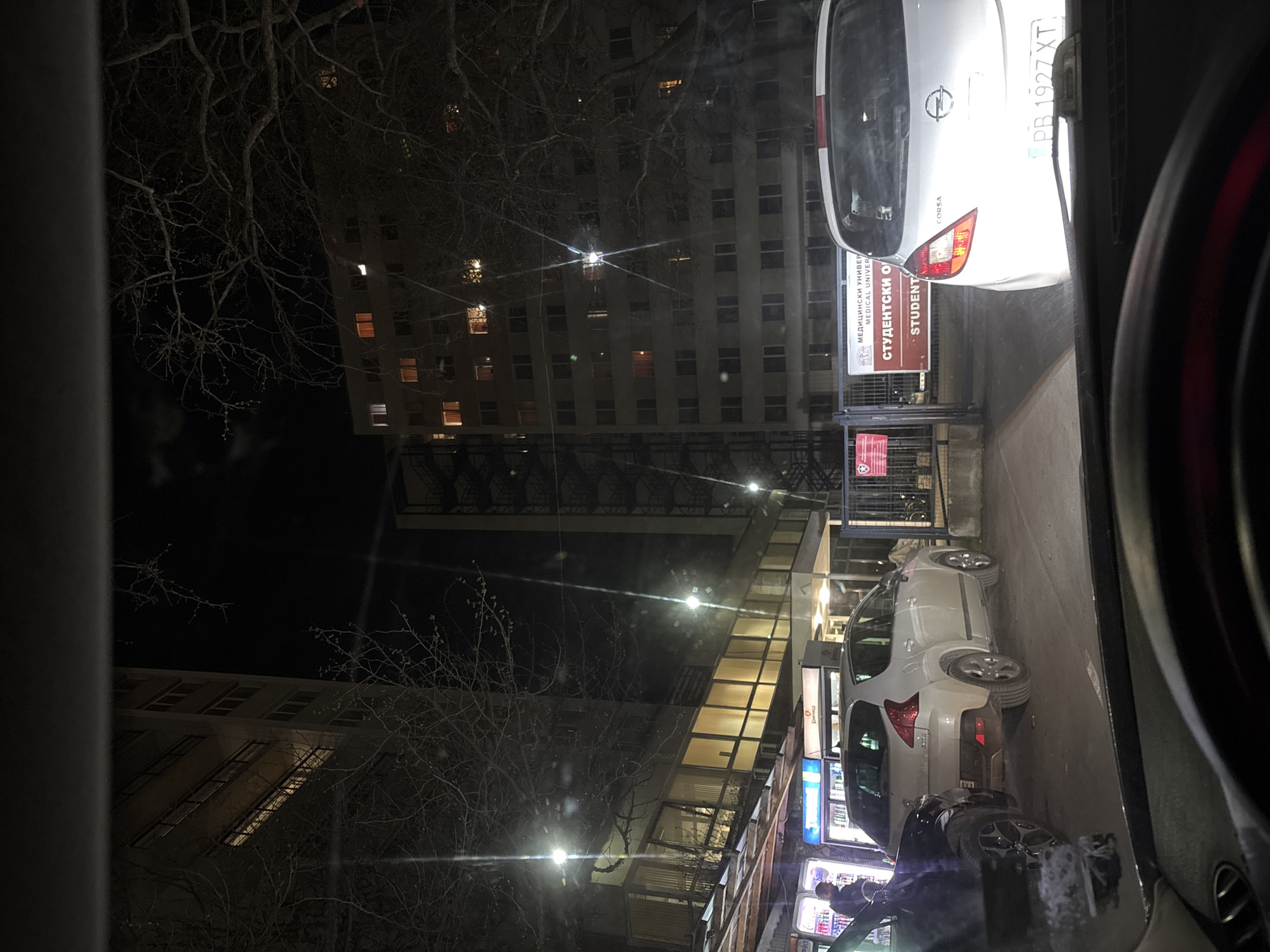 Two white cars parked on Plovdiv street at night