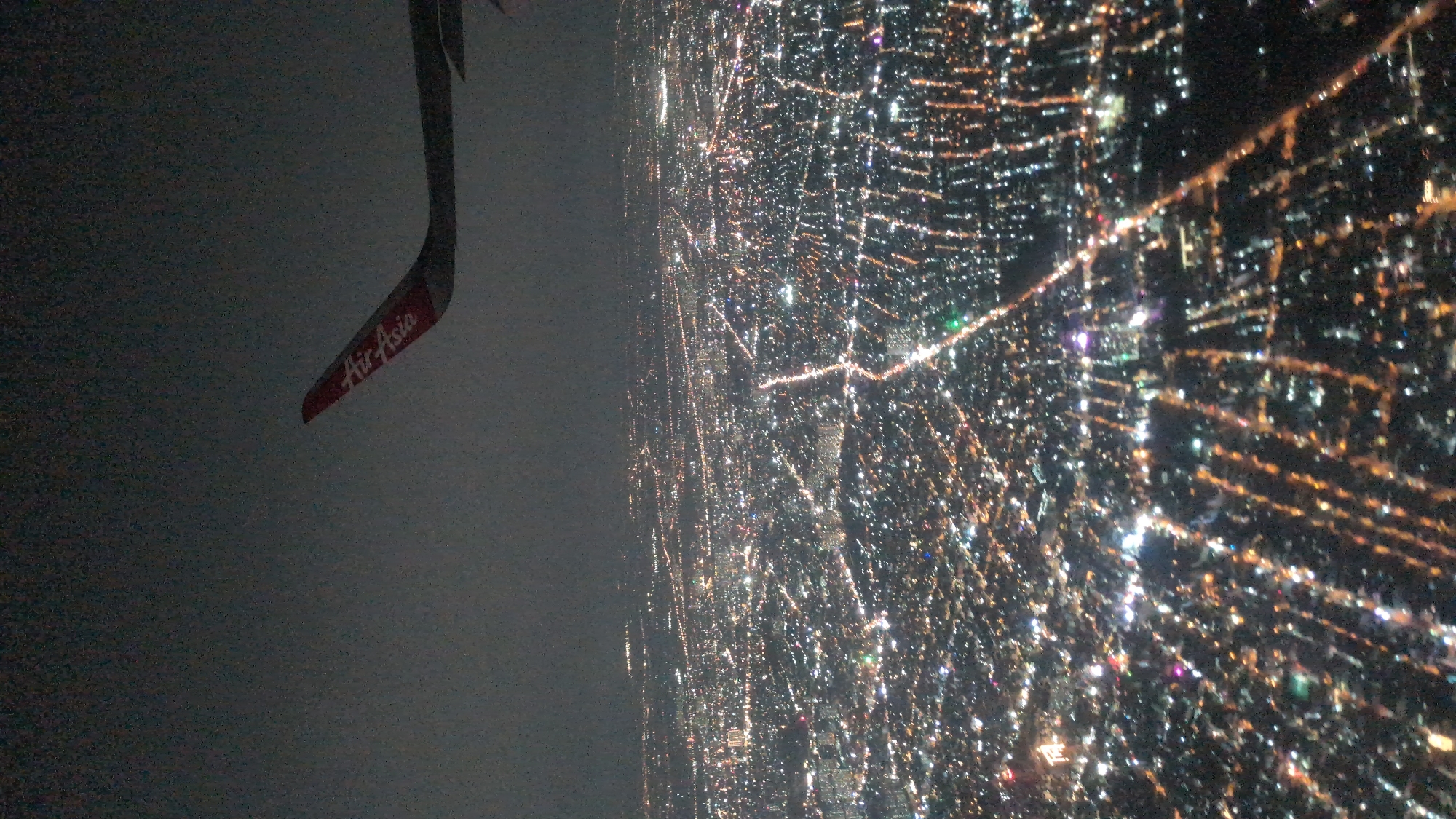 Aerial nighttime view of Ho Chi Minh City captured from airplane