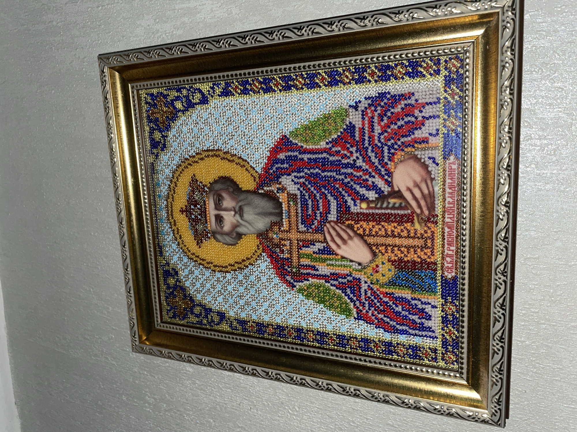 Religious icons and handmade crafts displayed in Brest interior