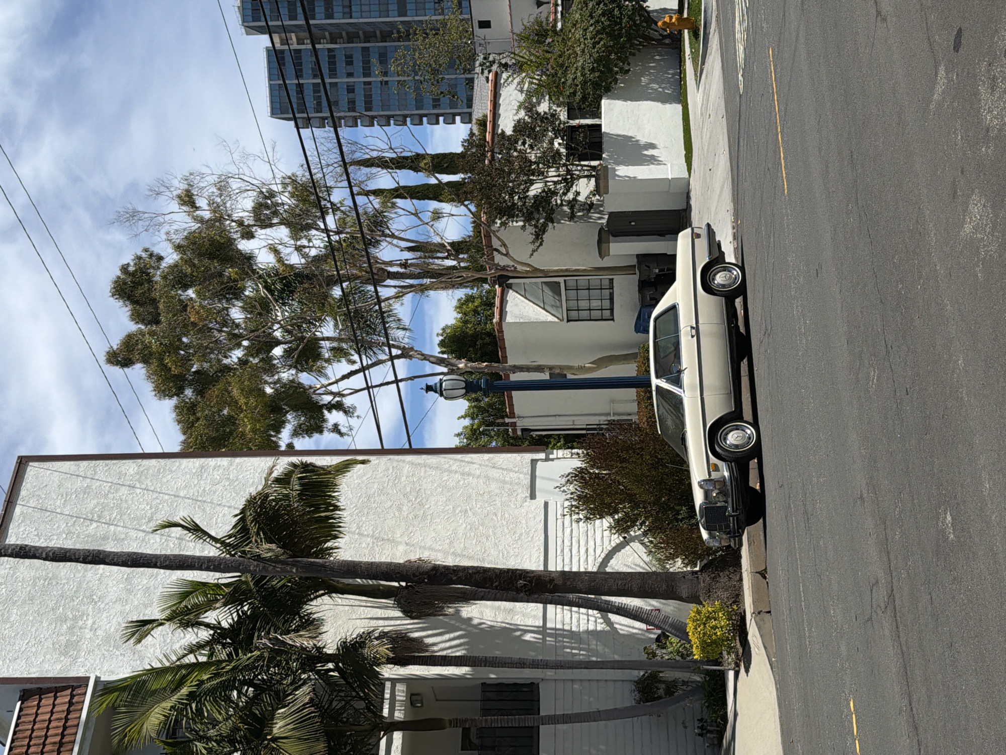 Vintage white Mercedes parked on a Long Beach residential street